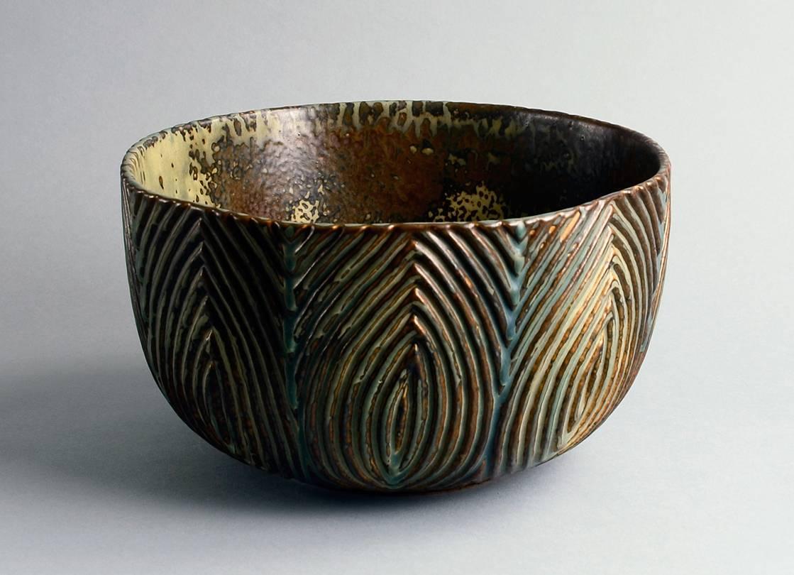 Large stoneware bowl with carved line pattern to exterior and Sung glaze in shades of brown, cream and blue, 1963.