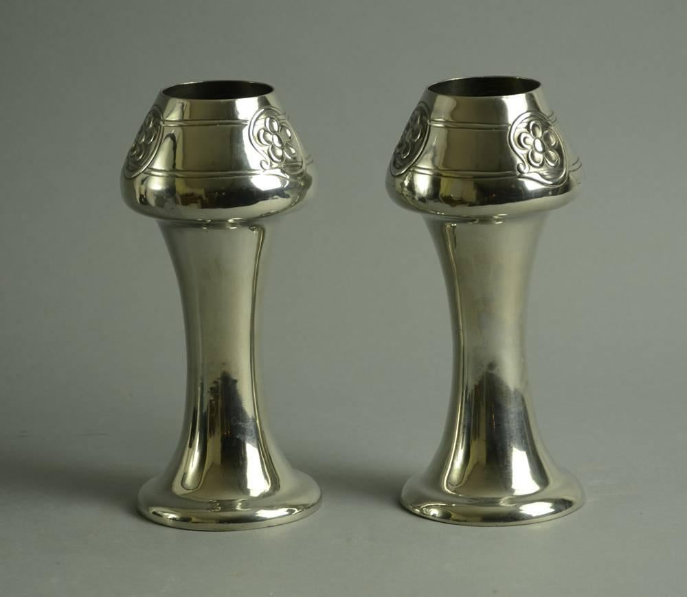 Pair of pewter vases with flower decoration, c1900s.