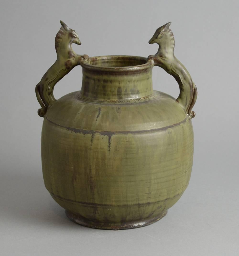 Unique stoneware urn with hand modelled handles in the shape of a pair of horses, olive green matte crystalline glaze, 1928.
