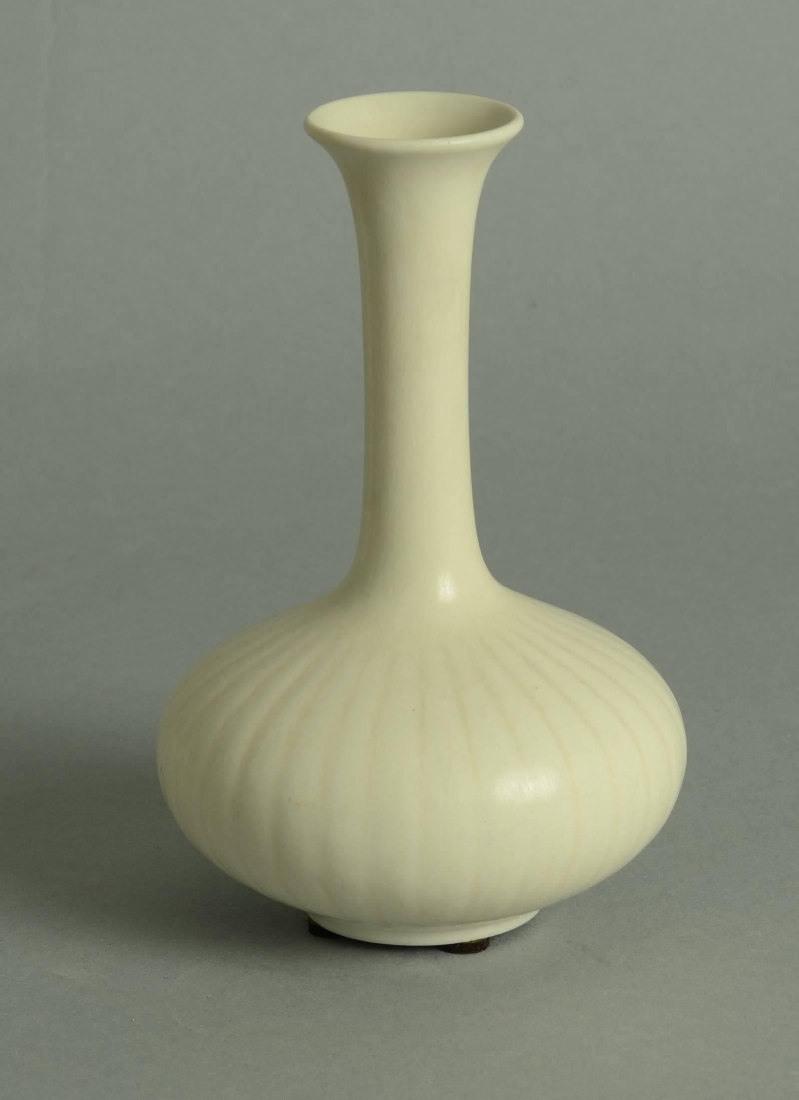 Five vases with matte white glaze by Gunnar Nylund for Rörstrand, Sweden, circa 1950s-1960s.

1. Stoneware vase with matte white glaze.
Height 16 1/4" (16 cm) width 4" (10 cm).
Incised "R (Three Crowns) Sweden GN" No.