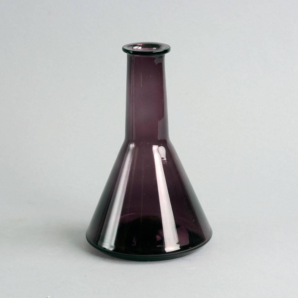 Tapio Wirkkala for Iittala, Finland

Bottle vase in purple glass, 1950s-60s.
Engraved "Tapio Wirkkala"
Height 7 1/4" (18.5cm), width 4 1/2" (11.5cm)

Timo Sarpaneva for Iittala

"i-glass" decanter in purple