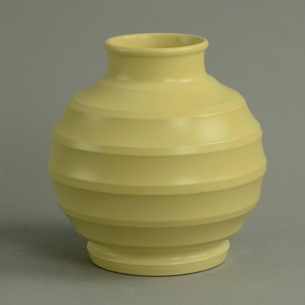 Keith Murray for Wedgwood

Porcelain ribbed vase with pale yellow matte glaze.
Height 7 1/2" (19cm) diameter 7" (18cm)
No. N2929

Stoneware vase with matte white glaze, 1930s.
Height 6" (15cm) width 5 3/4" (14.5cm)
No.