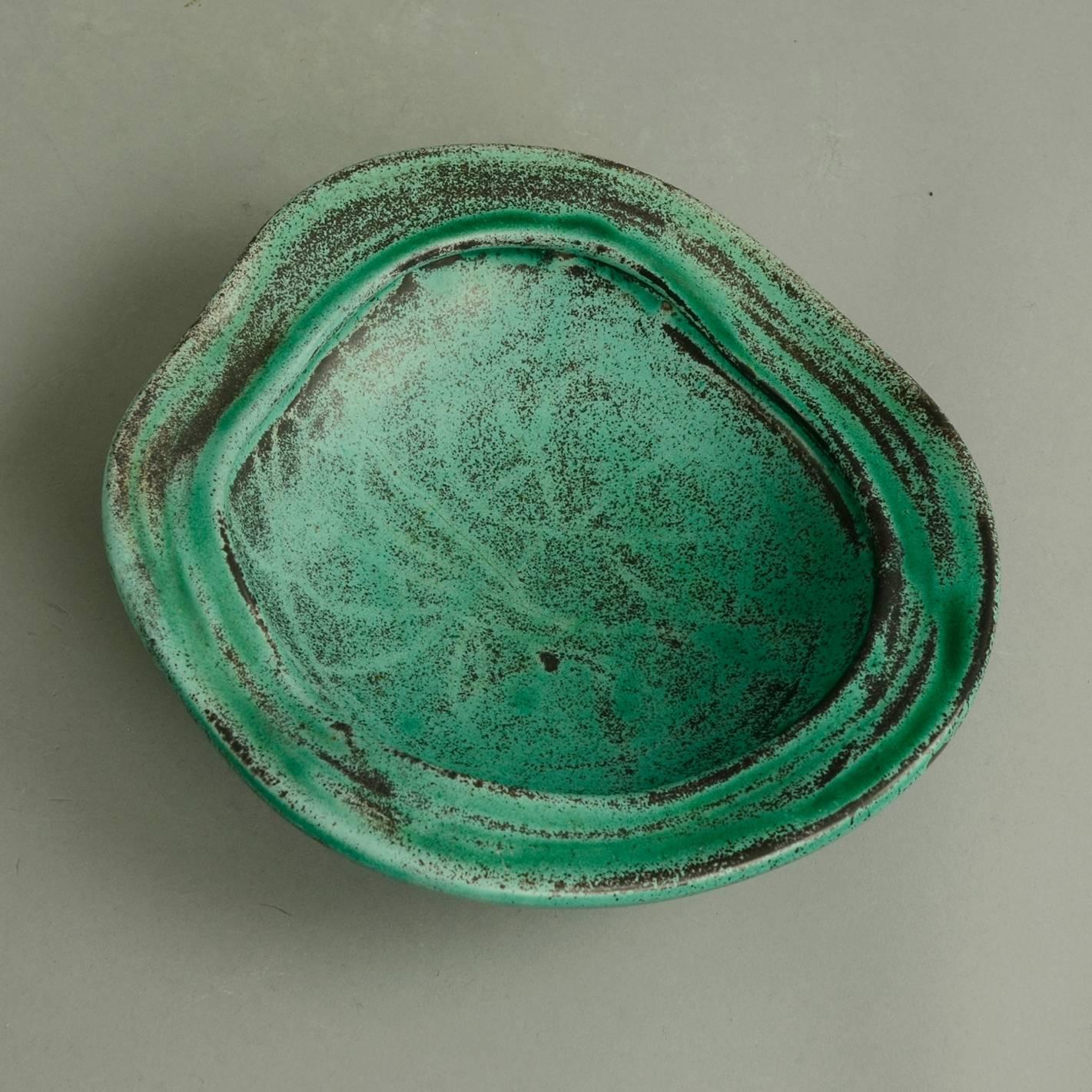Svend Hammershoj for Herman A. Kahler Keramik

Stoneware bowl with matte green and black glaze, circa 1930s
Measures: Height: 2 1/4" (5.5cm), width 8" (20cm) 
Incised "HAK Danmark" No. B3547

Stoneware vase with matte green