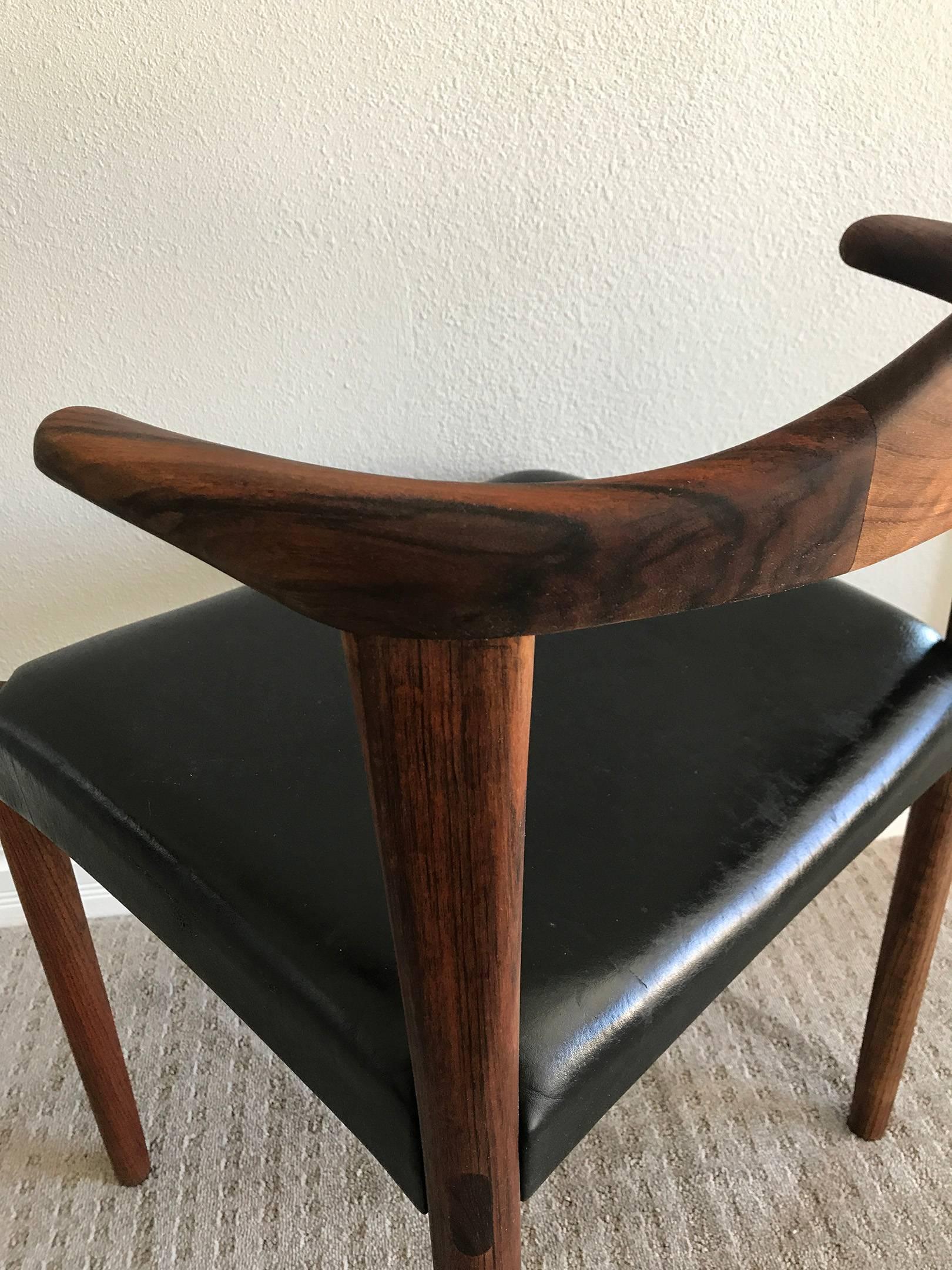 An exquisite, sculpted rosewood bull horn chair by Harry Ostergaard for Randers Mobelfabrik. 

A design similar to that of Hans Wegner's bull horn chair; this hand-sculpted chair is composed of solid rosewood and has incredible detailed rosewood