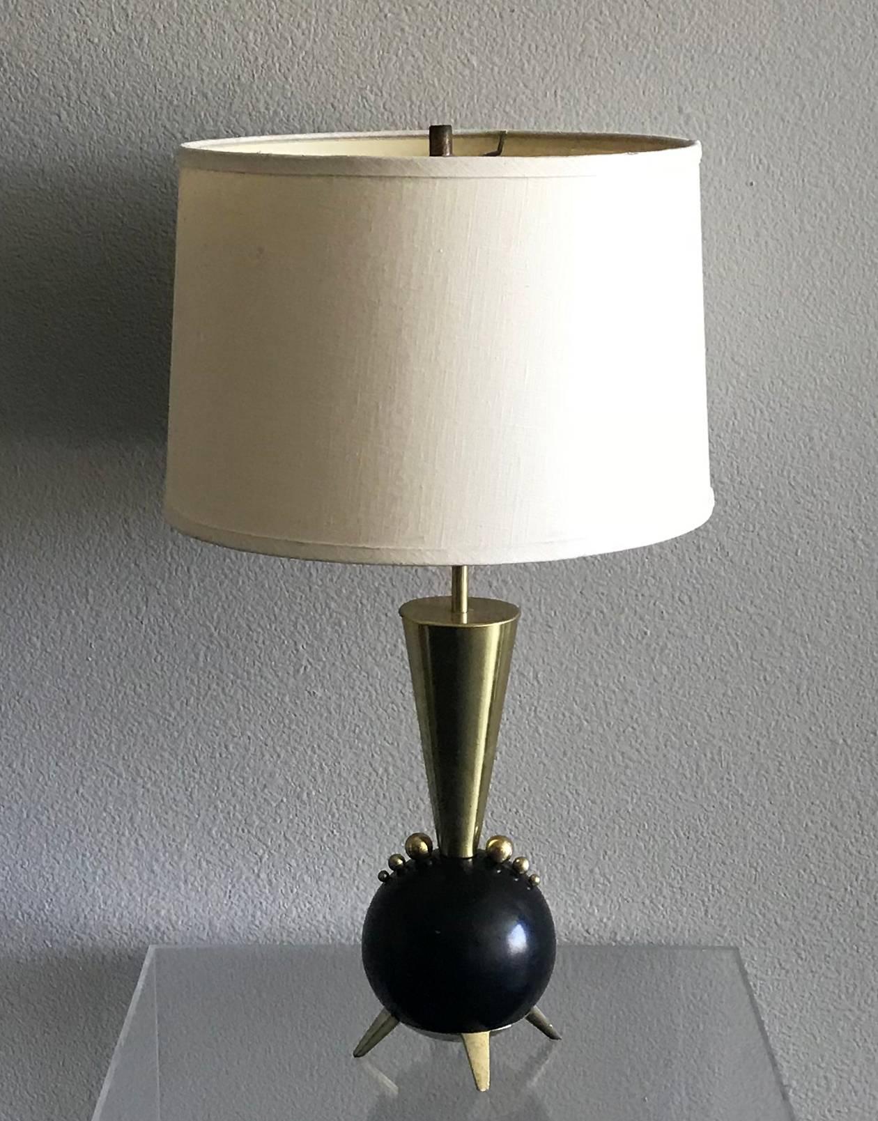 An absolutely stunning pair of Rembrandt orb table lamps. The lamps feature black orbs with brass ball decorations, brass body and neck. These lamps epitomize mid century modern style, but effortlessly can be paired with contemporary, boho chic and