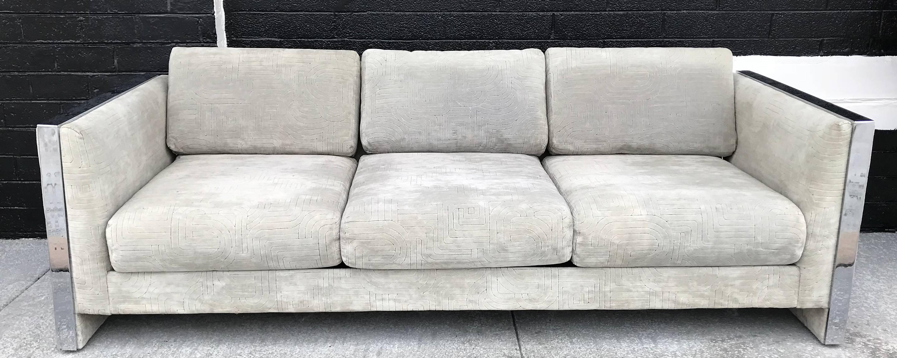 A gorgeous sofa by Selig Monroe. This 1970s sofa features chrome accented sides, and a bold tone on tone geometric patterned light grey velvet upholstery. Very Milo Baughman in style!