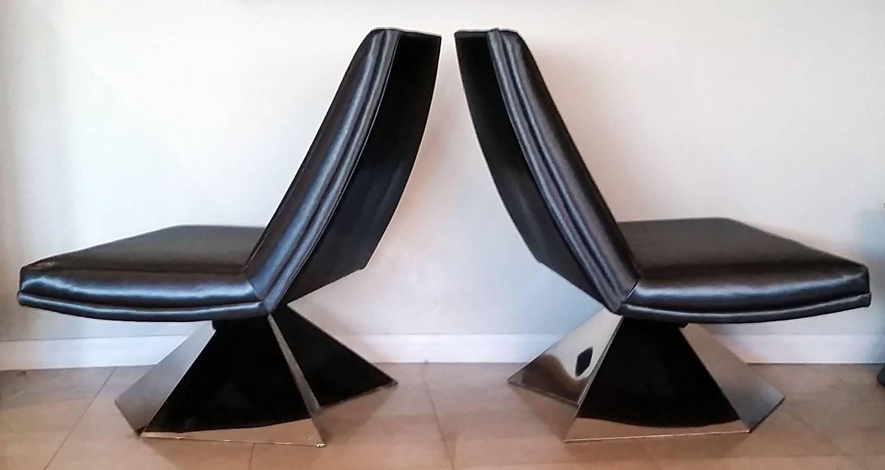 A stunning pair of 1970s lounge chairs. These large chairs sit atop molded chrome bases and are very Space Age modern. For scale purposes, the chairs have been photographed opposite of an Eames compact sofa.

The chairs are upholstered in a
