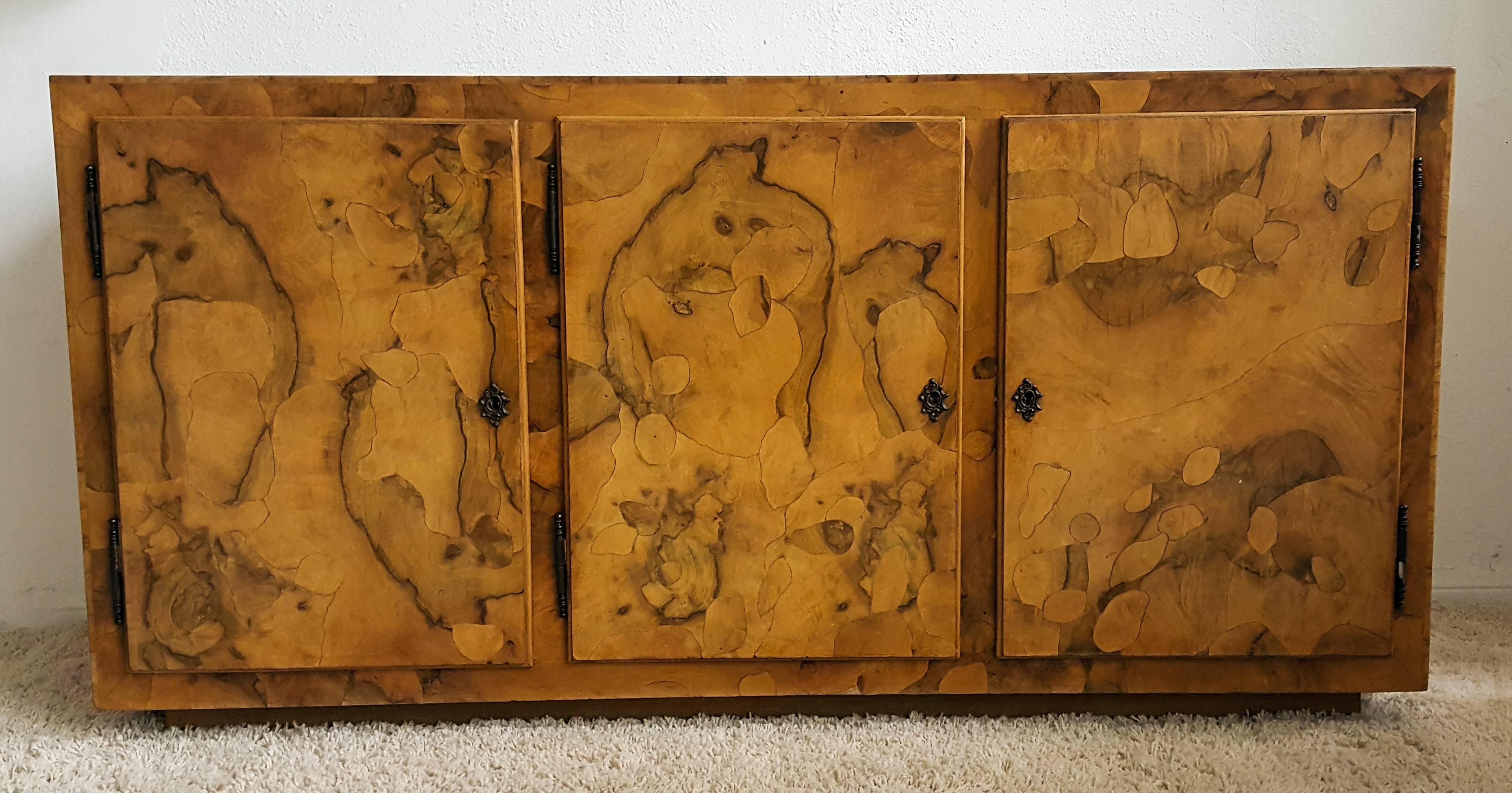 This credenza is stunning! The credenza features a fine patchwork burl design that mimics an almost tortoise shell finish. The craftsmanship on this piece can be seen in the attention to detail. Comes with its original skeleton key.