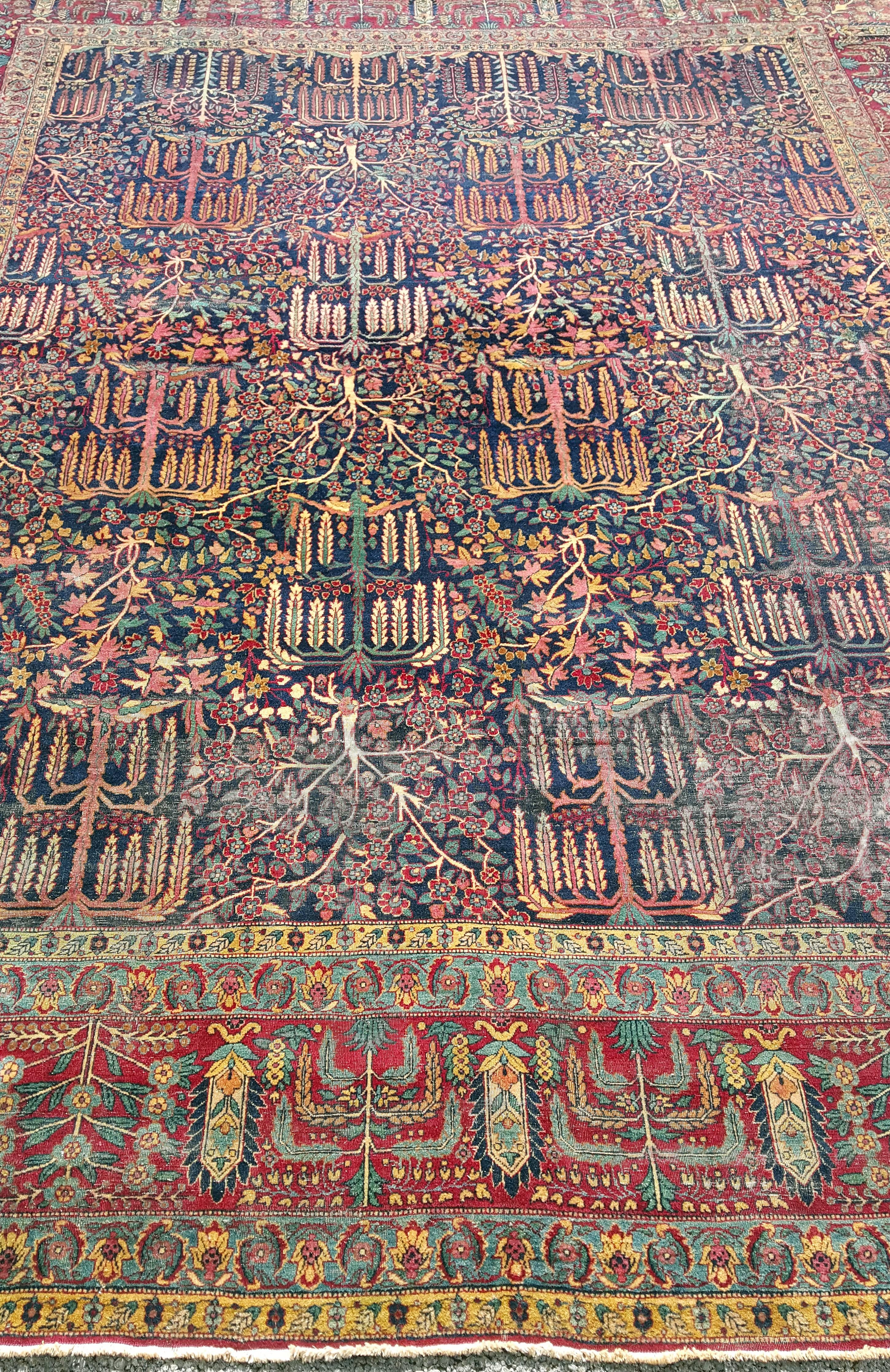 An absolutely stunning Persian (Iranian) rug. This 1930s finely hand-knotted Kerman rug features jewel tones and a plethora of jewel tone colors all blended together in perfect harmony. The rug also features rare tree of life and willow designs.
