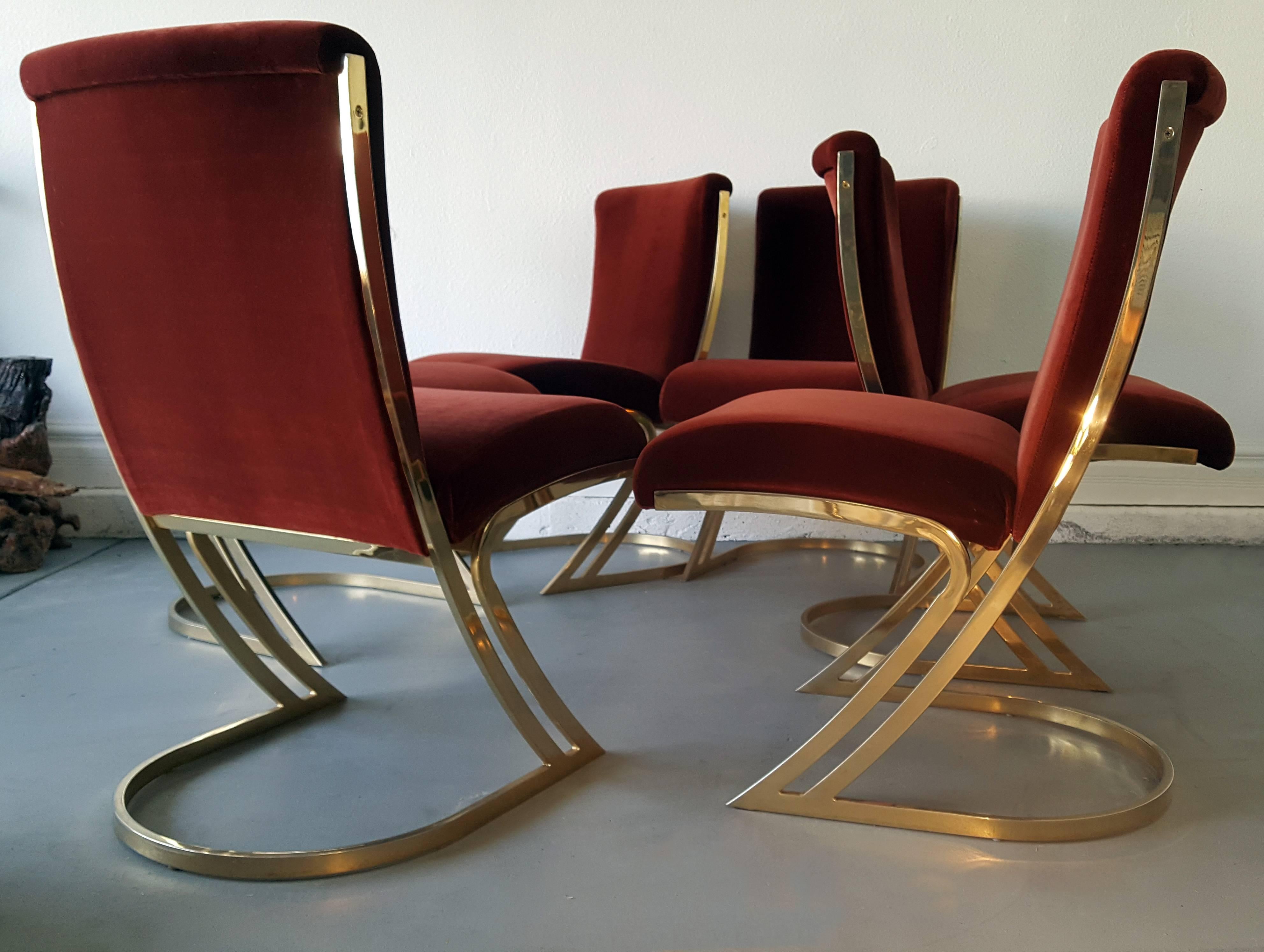 A stunning set of six Mid-Century Modern / Regency styled Pierre Cardin design, brass dining chairs upholstered in an oxblood colored velvet. In great condition with minimal wear to commensurate with age.