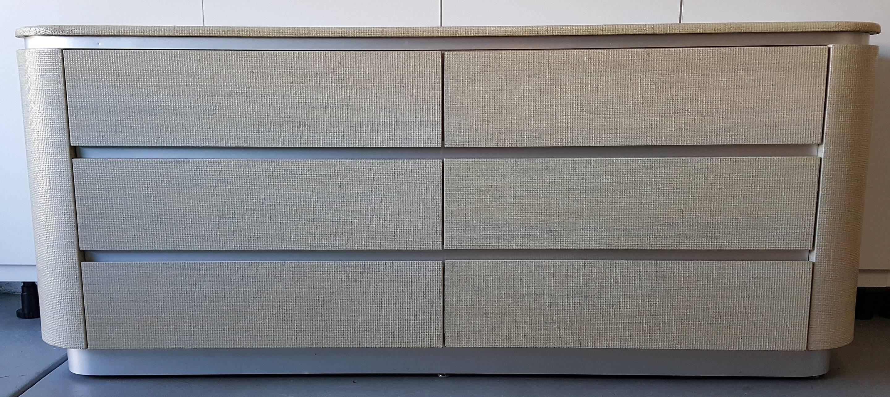A stunning Harrison Van Horn modern/contemporary dresser covered in raffia with a brushed chrome base and trim.