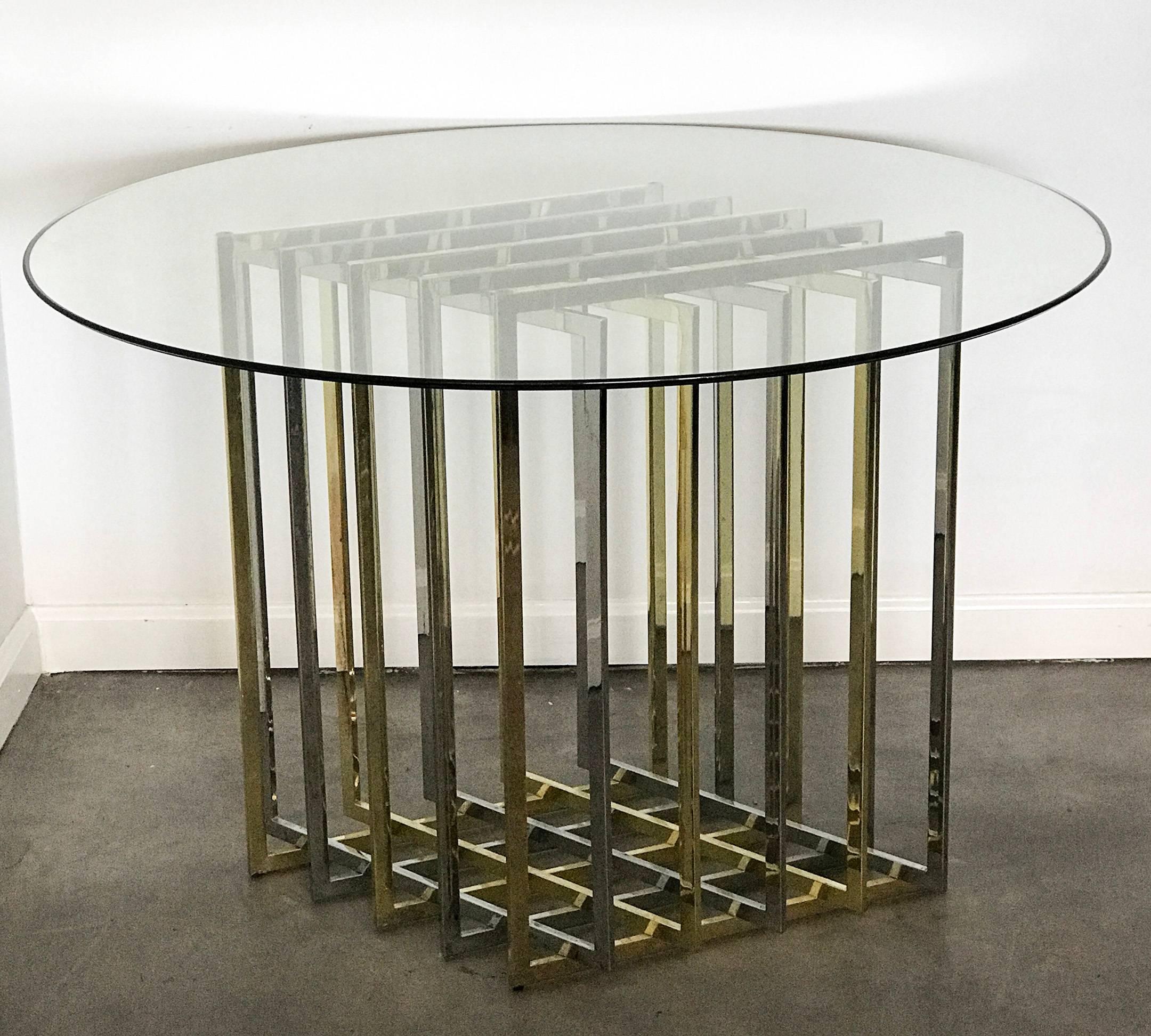 A stunning chrome and brass grid or cage dining table in rare diamond formation. The table has a glass top that measures 42