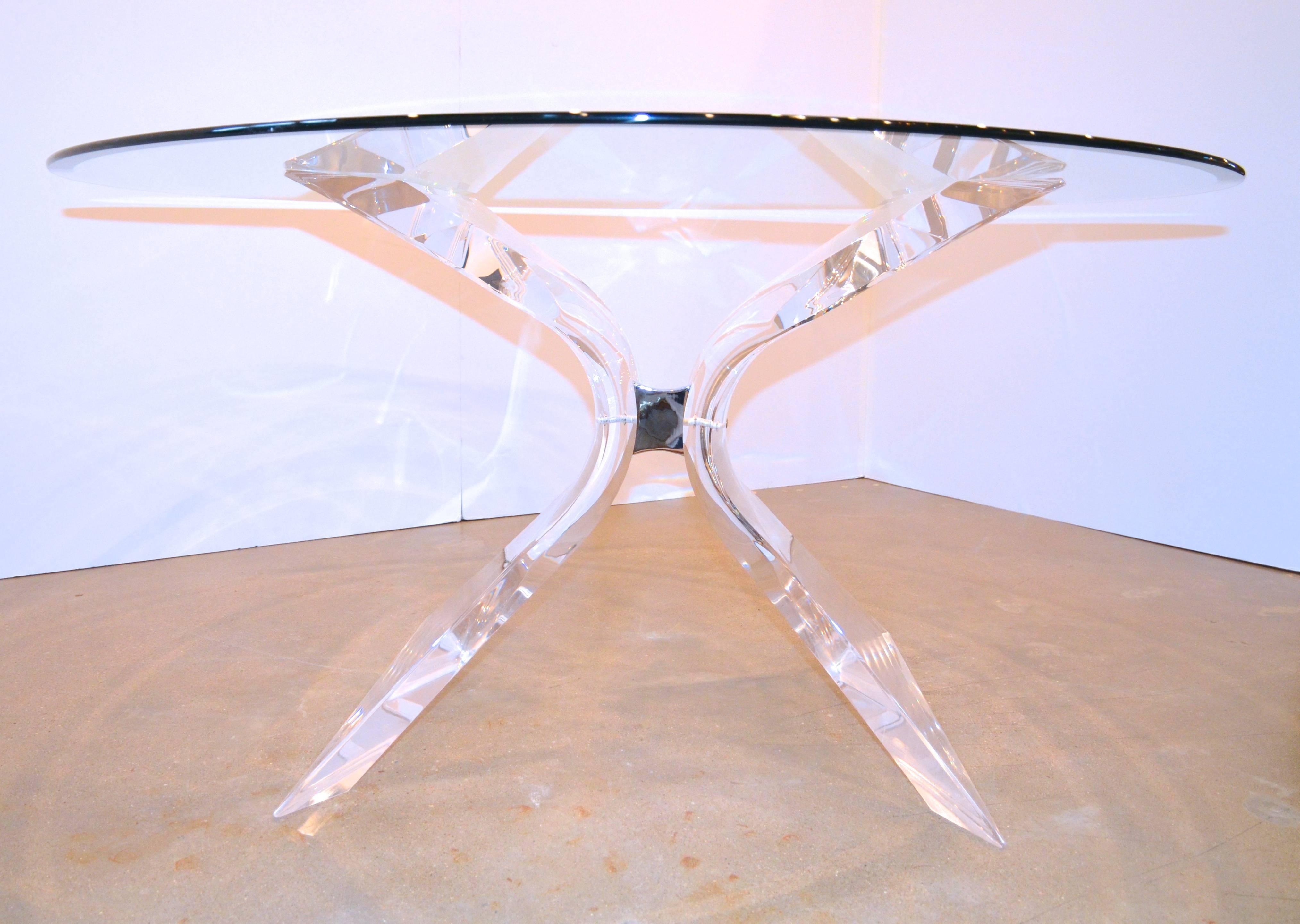 Beautiful Mid-Century Modern thick Lucite, glass and chrome dining table by Lion in Frost. Hollywood Regency style butterfly shaped clear Lucite base connected with a chrome plate, supports a thick beveled glass top. Table base able to accept larger