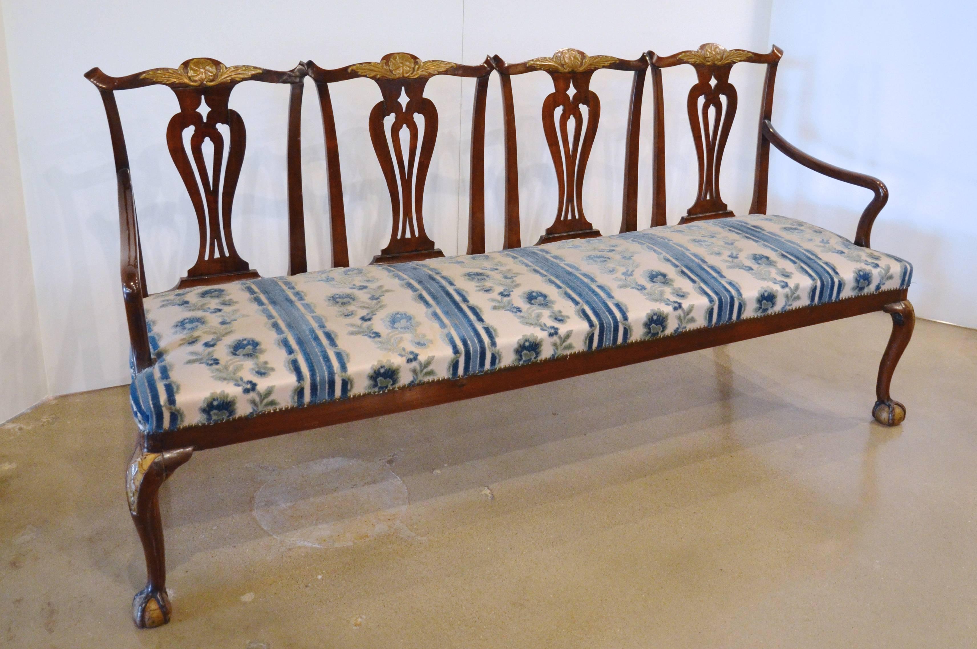 A very good quality Chippendale style carved mahogany four chair back settee, with a slip seat. Possibly American.