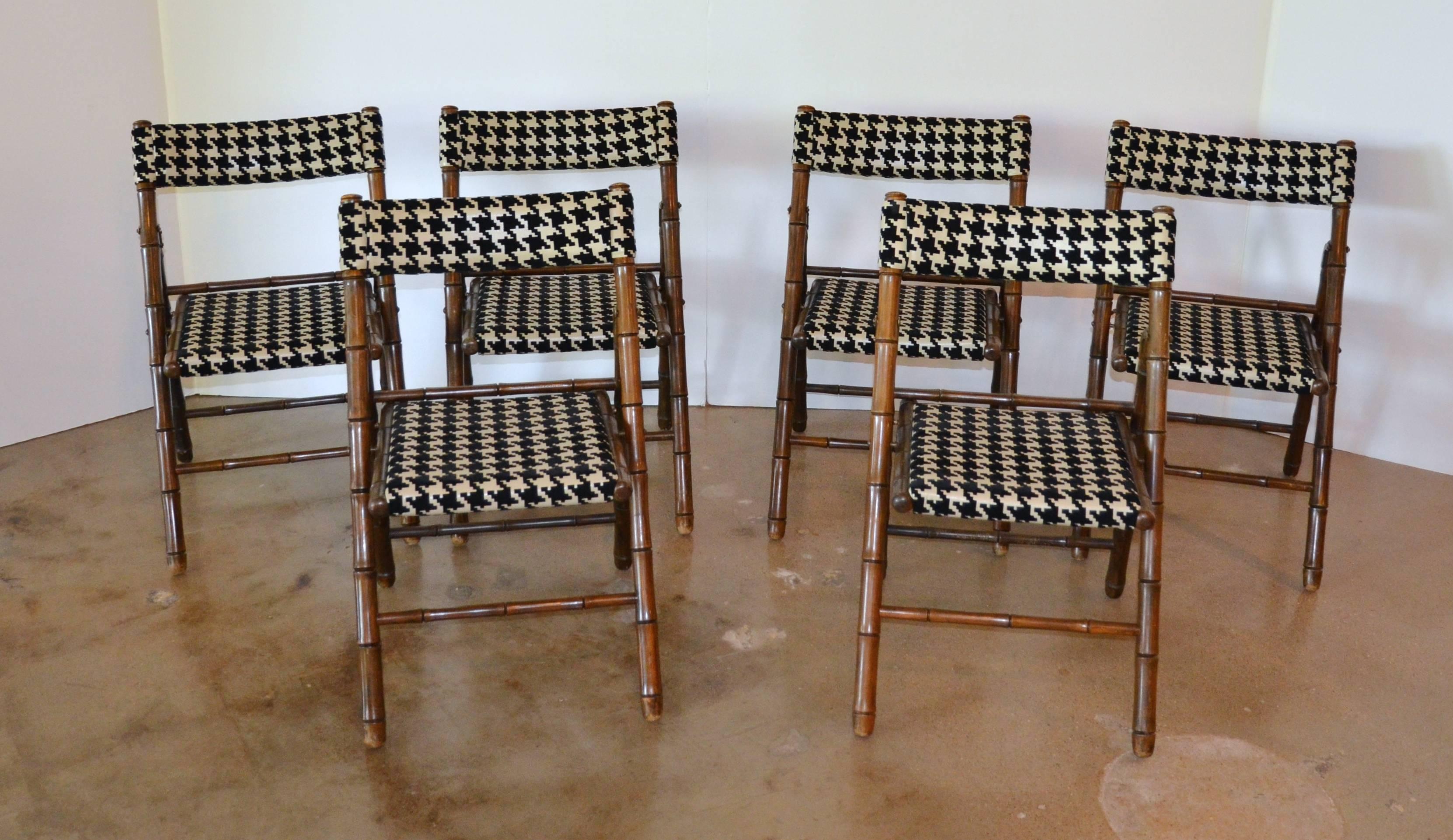 A set of six faux bamboo wood folding chairs newly reupholstered in a large-scale flocked houndstooth. In the manner of Billy Haines, 1960's.