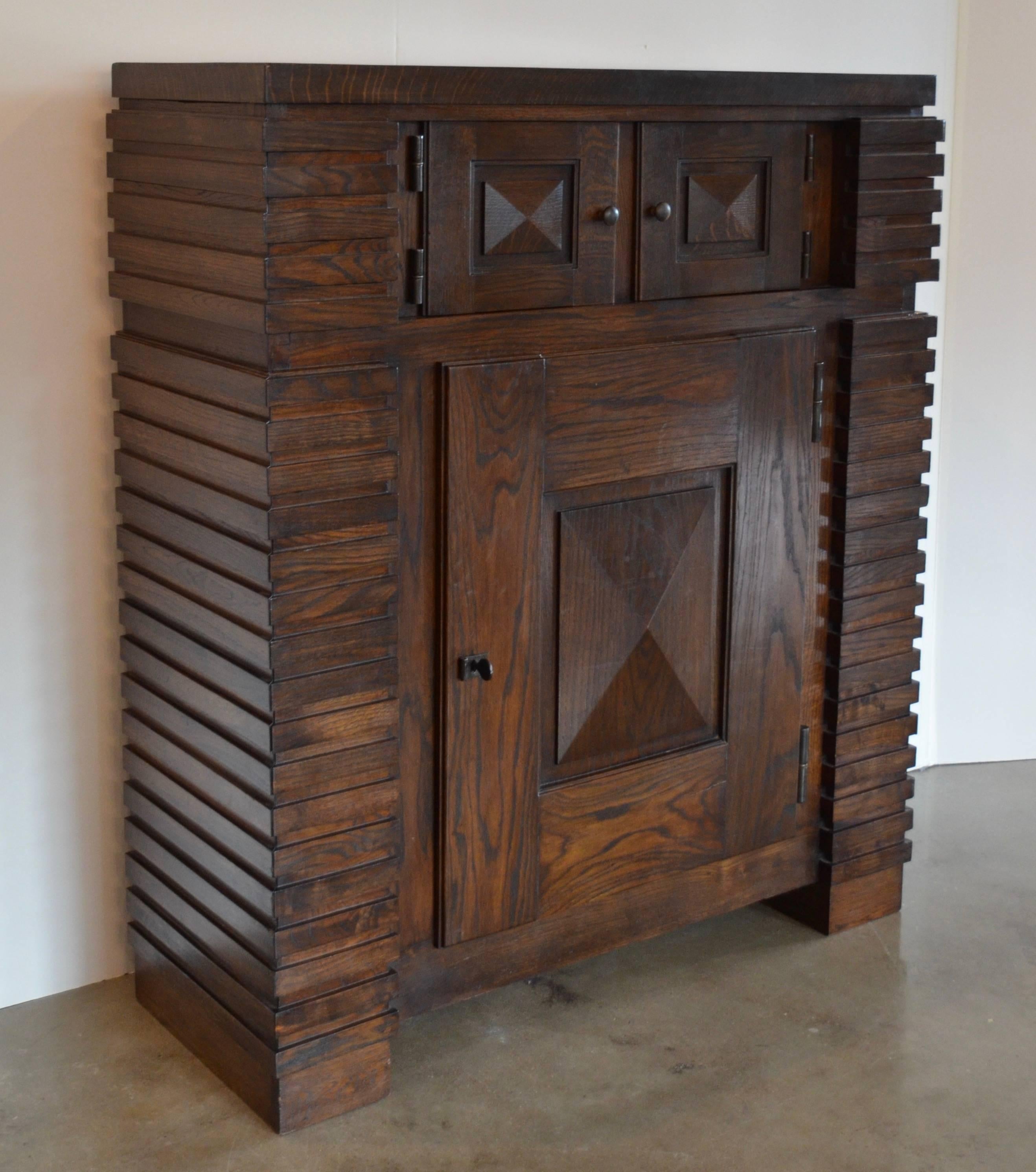 Famed French architect, Jacques Le Même designed furniture that clearly reflects his roots in the built structure. Cubic cabinet, circa 1930s, of fumed oak, in excellent condition. Shelves are adjustable.

Early modernism, deco, Mid-Century,