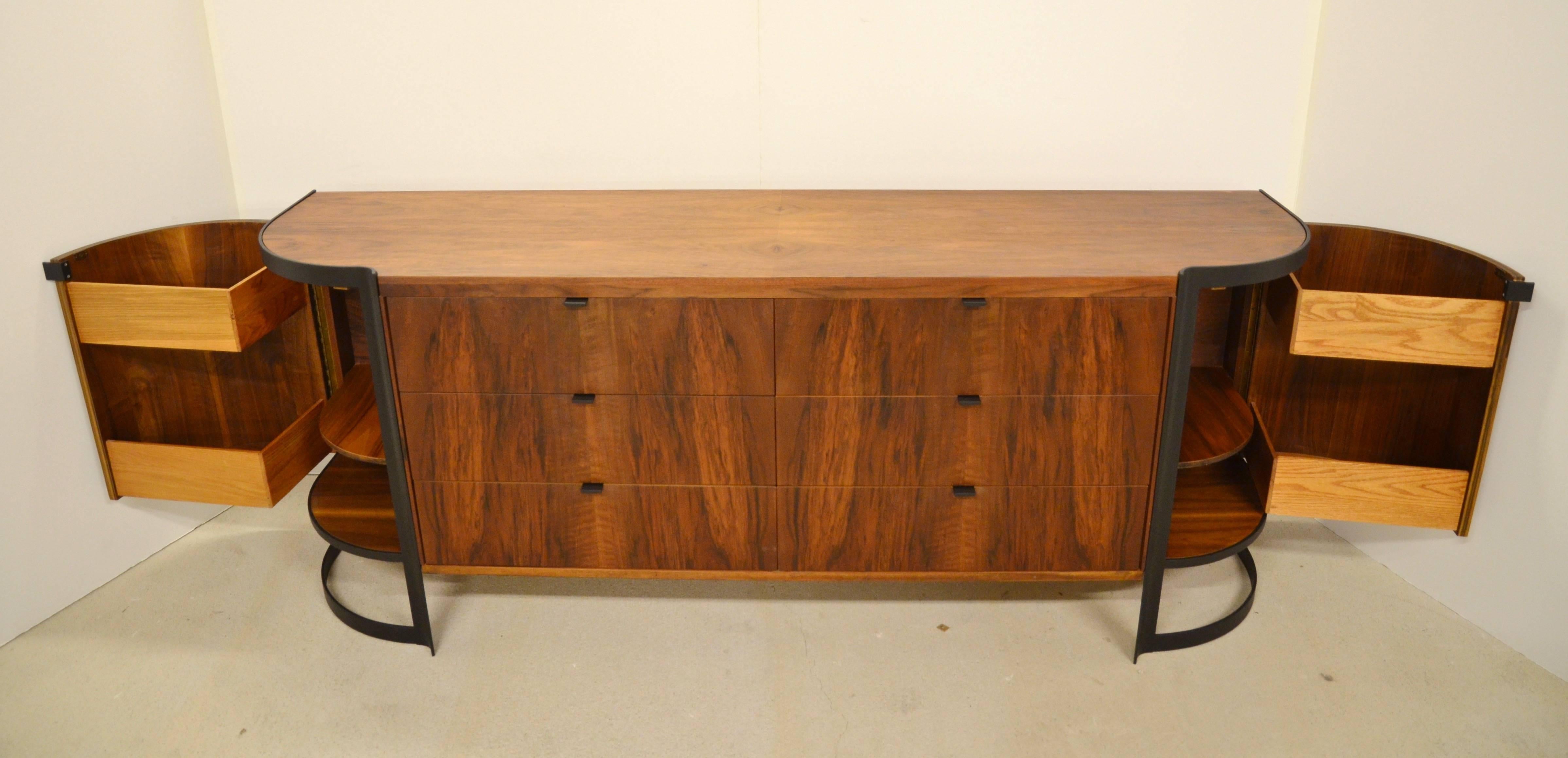 A Mid-Century flamed wood and steel sideboard or dresser with unique shape and hardware. Six drawers and curved side panels that open to reveal additional storage. Newly powder coated black steel hardware and original label attached. Original