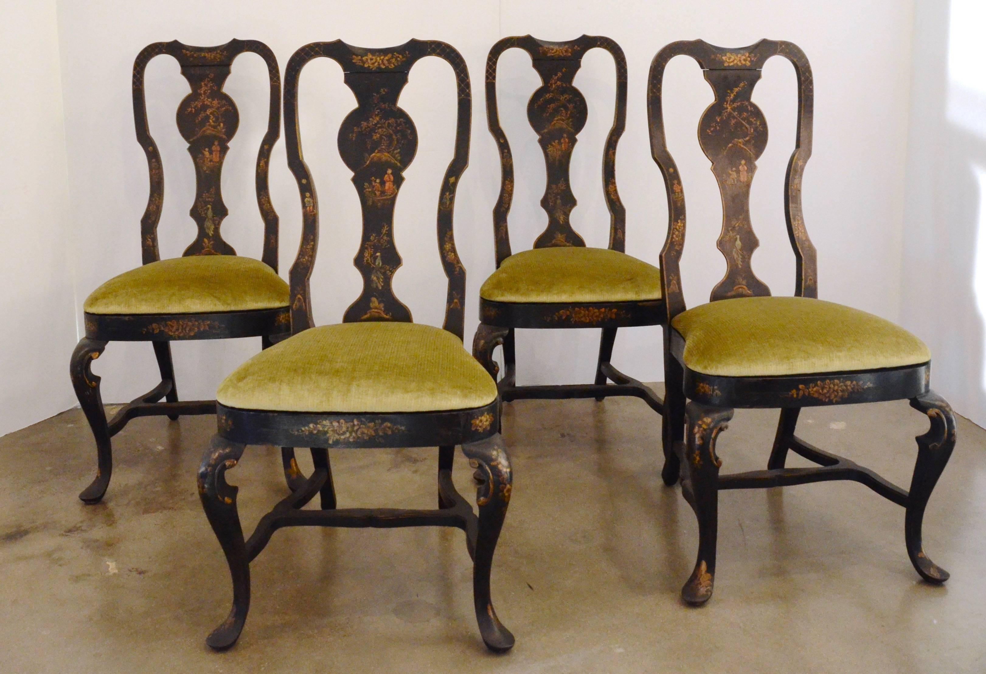 Superb set of six black chinioserie dining chairs (two-arm chairs and four side chairs). Ebonized Queen Anne style frames with vasiform splat backs and cabriole legs. Painted and gilt decorative imagery details children playing under the watchful