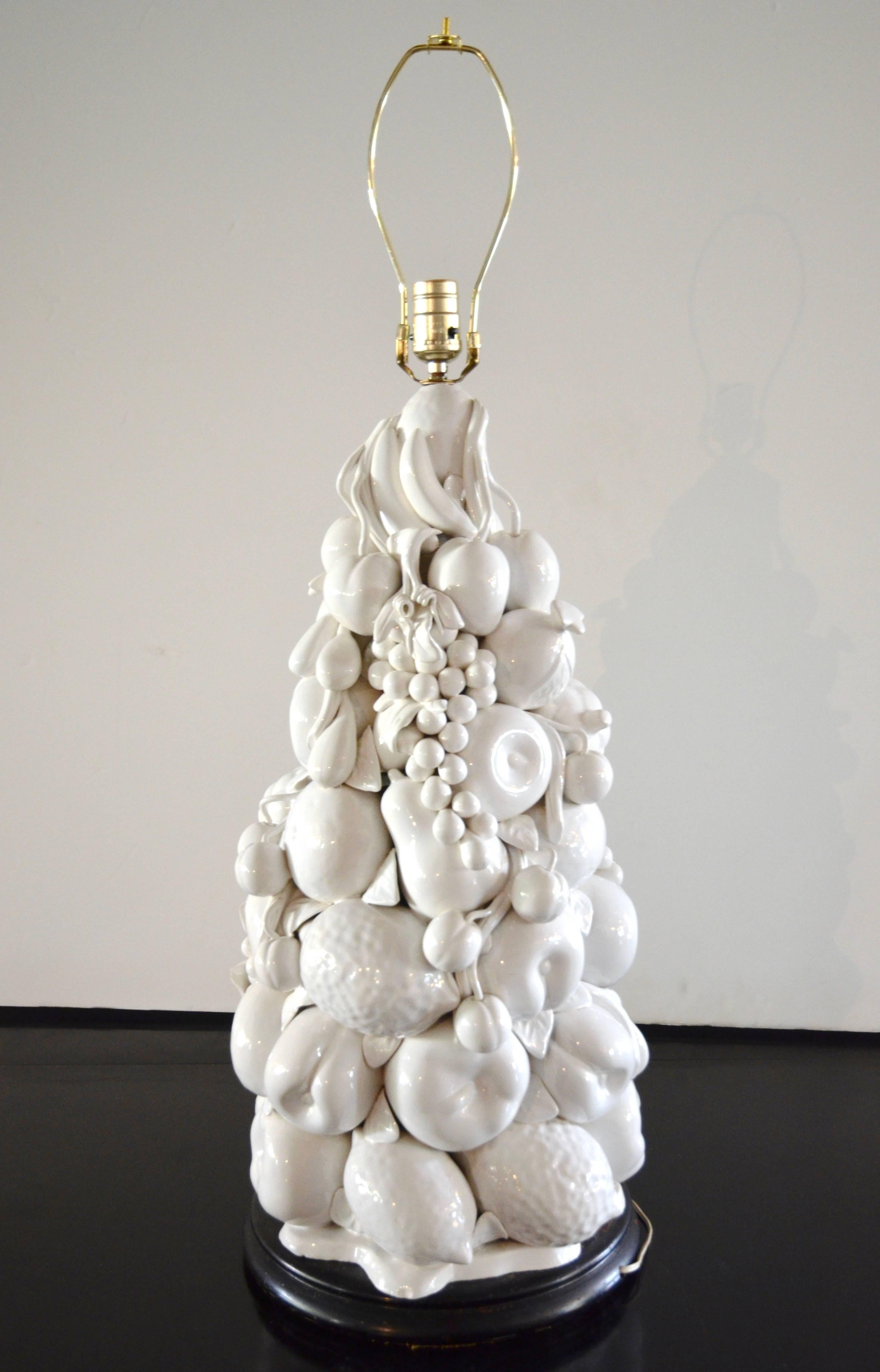 Large white porcelain Italian topiary lamp on black wood base. Highly detailed with a variety of fruits including apples, lemons, pears, grapes etc. Very impressive scale. Height (38
