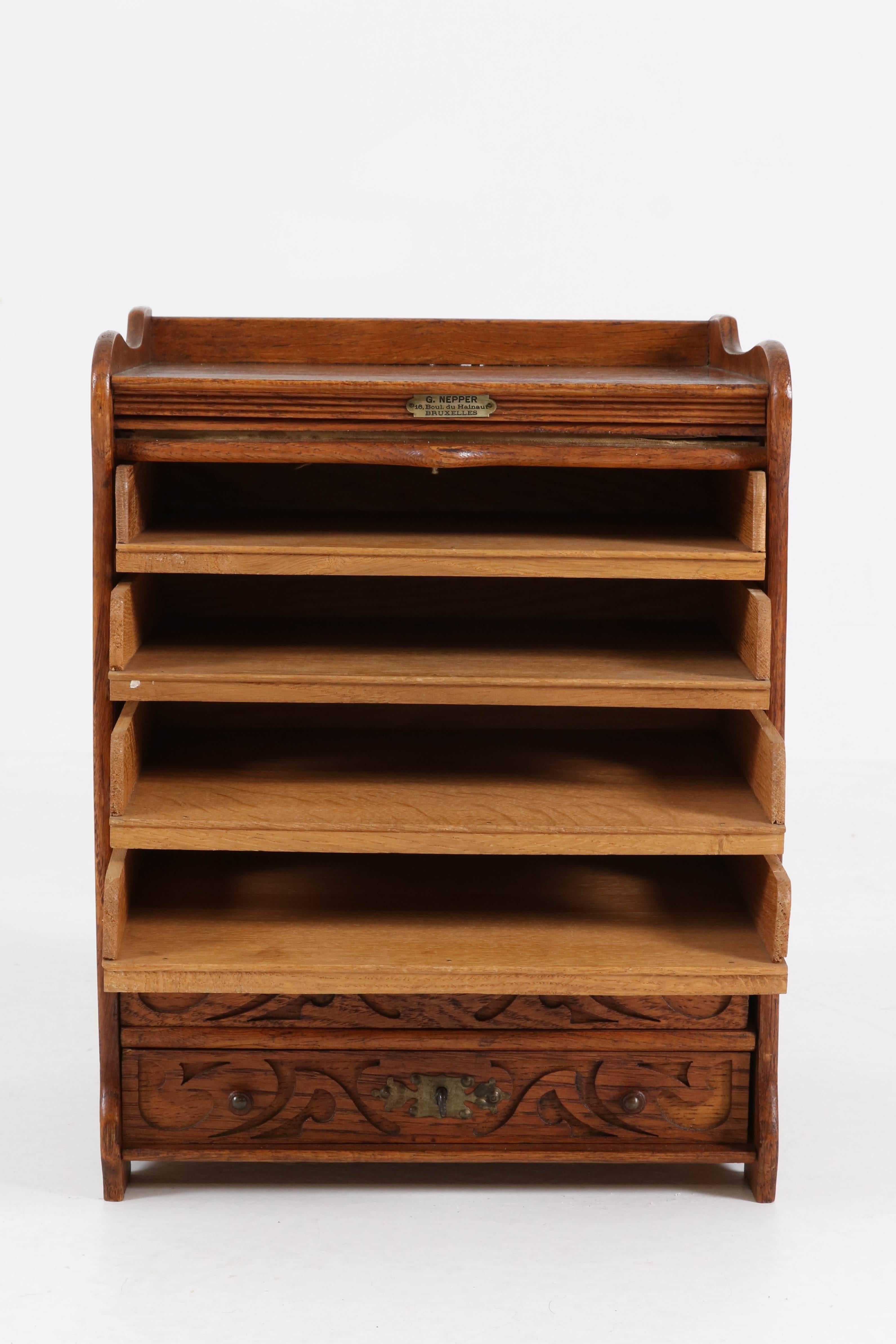 Elegant and rare miniature Art Nouveau file cabinet by G.Nepper Bruxelles, 1900s.
Solid oak with six original drawers.
Marked with metal tag.
In good original condition with minor wear consistent with age and use,
preserving a beautiful patina.