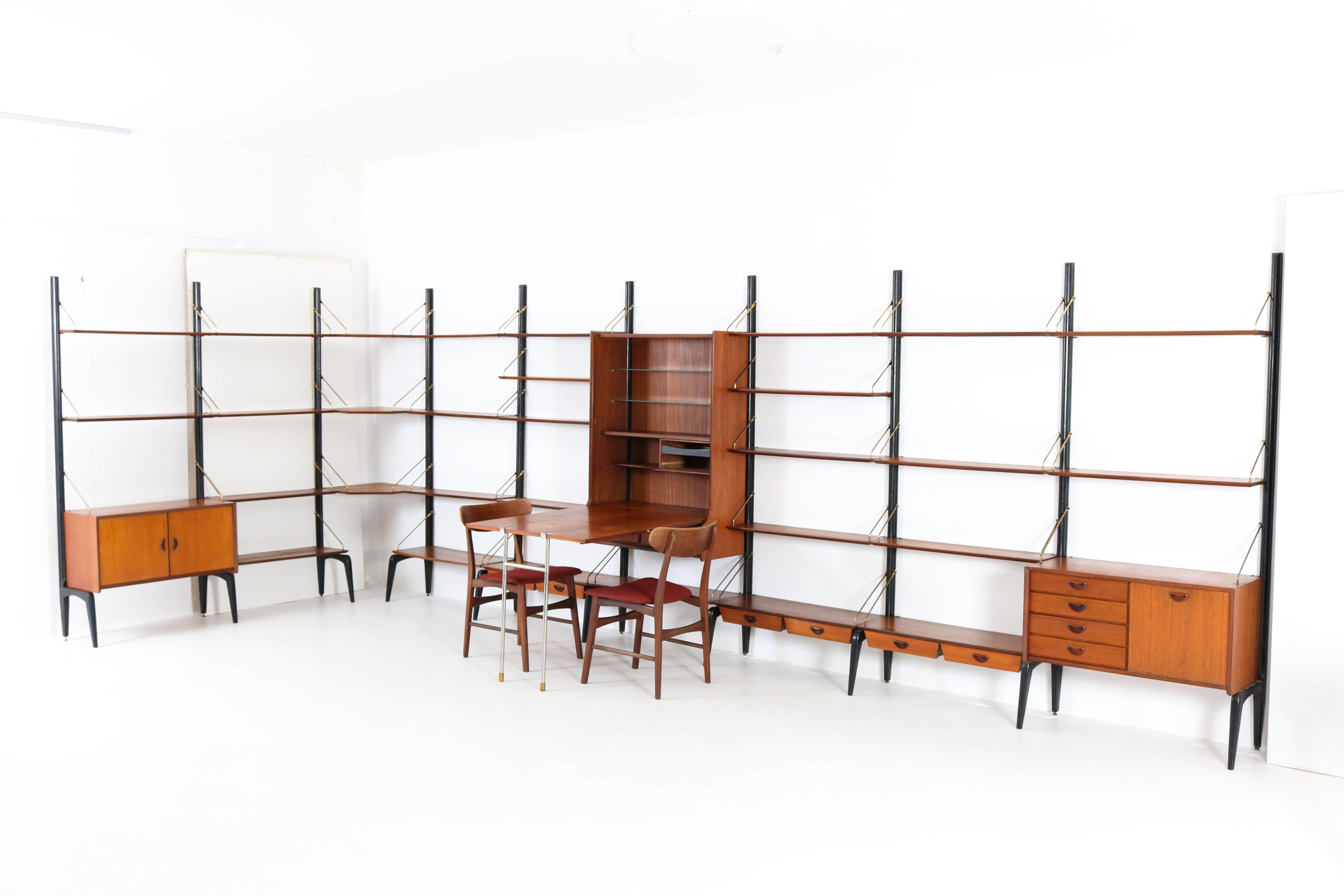 Impressive and very rare Mid-Century Modern extra-large freestanding wall unit by Louis Van Teeffelen for Webe, 1950s.
Original black lacquered wood, teak veneer and brass support rods with signs of wear and age.
This shelving system