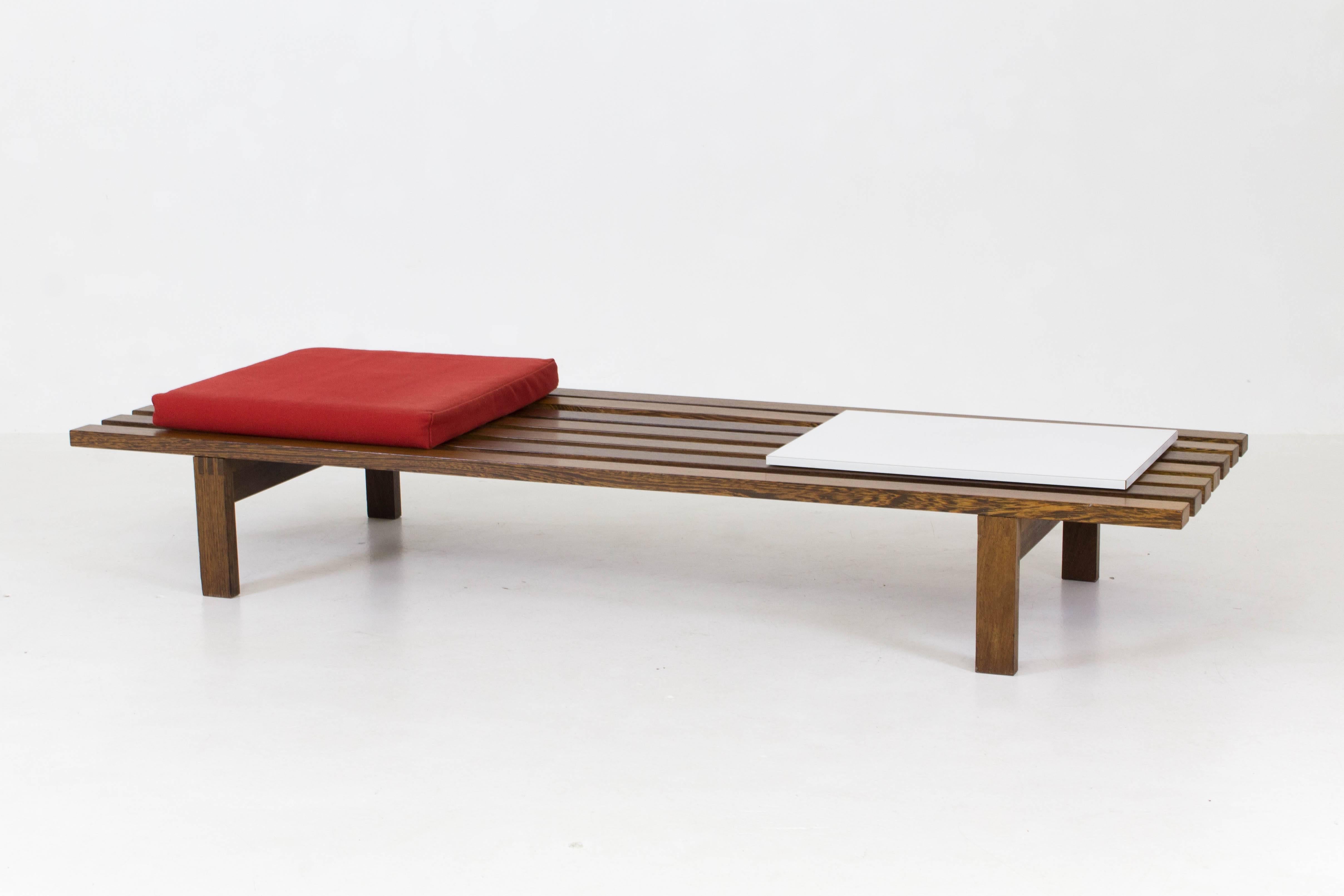Offered by Amsterdam Modernism:
Large wenge Mid-Century Modern slat bench by Martin Visser for 't Spectrum, 1960s.
This is the rare version with original cushion and sliding laminated shelf.
Marked with manufacturers label underneath the sliding