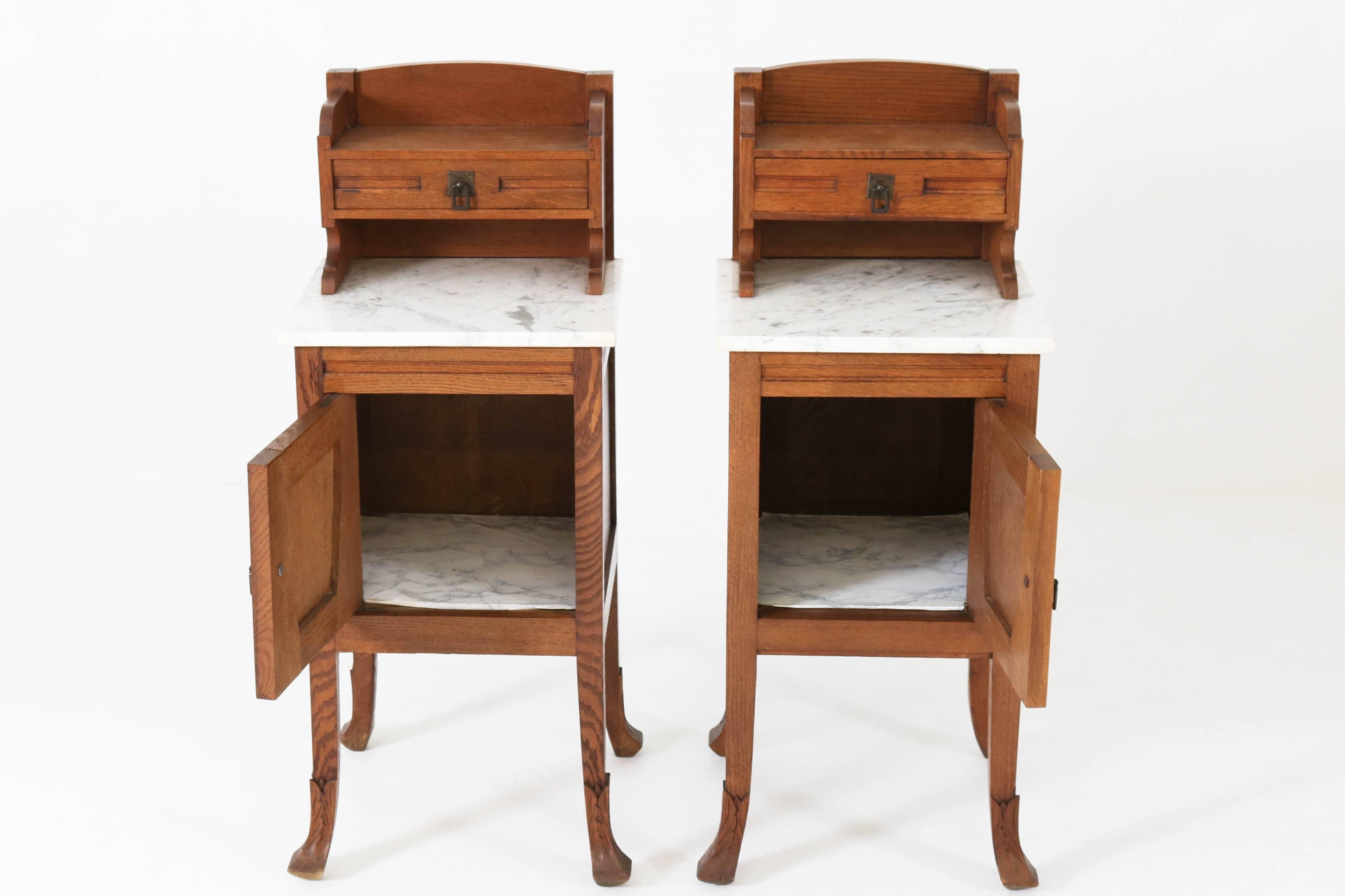 Wonderful pair of oak Dutch Art Nouveau nightstands, 1900s.
Solid oak with original marble tops.
Original brass handles on doors and drawers.
This pair is in very good condition with minor wear consistent with age and use,
preserving a beautiful