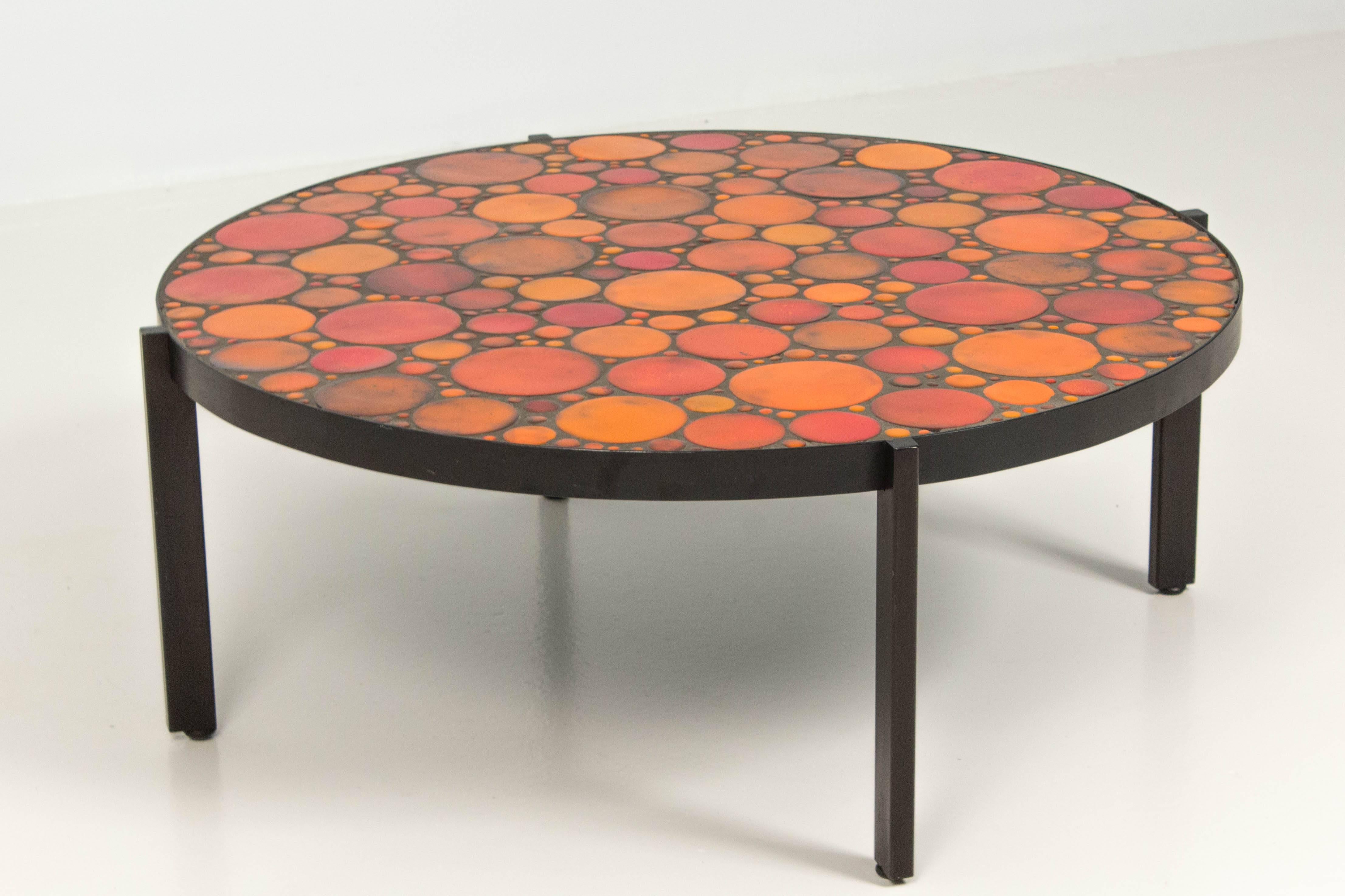 Mid-Century Modern coffee table with mosaic tile top, 1960s.
Black lacquered metal frame.
The top is inlaid with various orange ceramic tiles.
In very good condition.