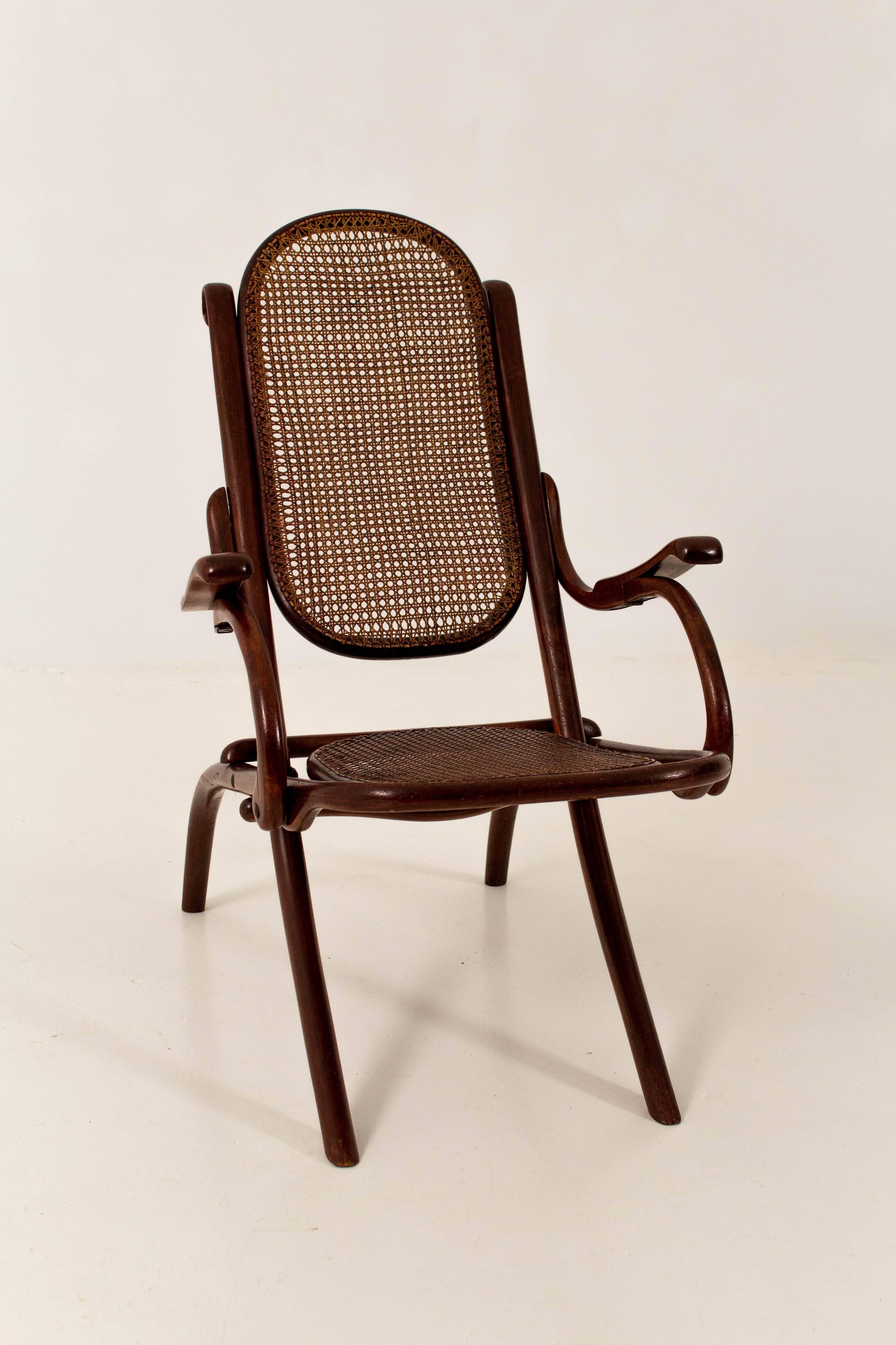 Thonet fold chair Austria 1890s.
Mahogany stained beechwood.
Original cane seating and back.
In good condition.