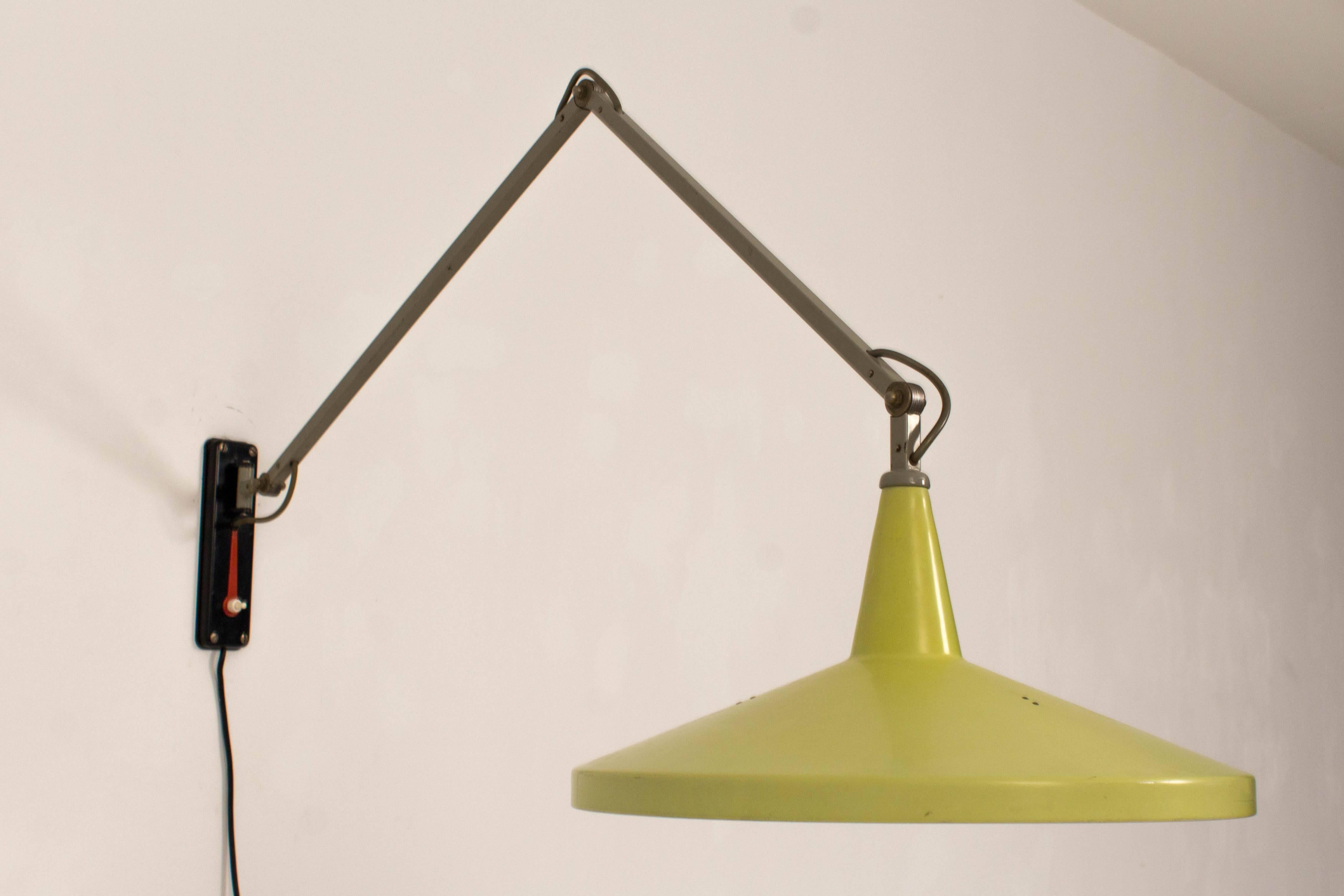 Rare lime color Panama wall lamp by Wim Rietveld for Gispen.
This adjustable metal wall lamp has the original diffuser.
The red metal ornament can be used as a tool for 
repositioning the lamp.
In good original condition with minor wear