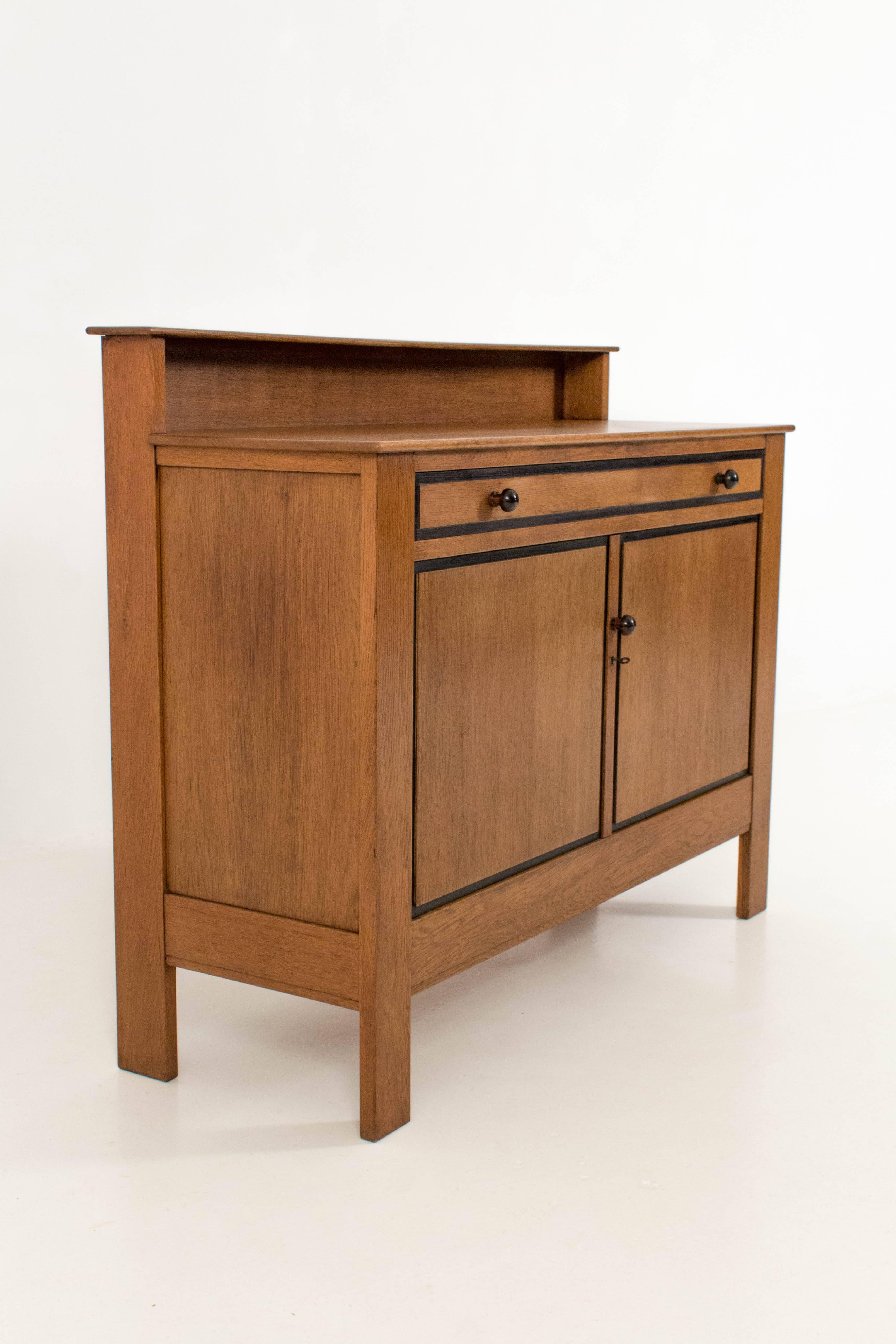 Striking Art Deco Haagse school oak sideboard by J.A.Muntendam for L.O.V.
Original and solid ebony Macassar knobs on drawer and door.
In good original condition with minor wear consistent with age and use.
Preserving a beautiful patina.