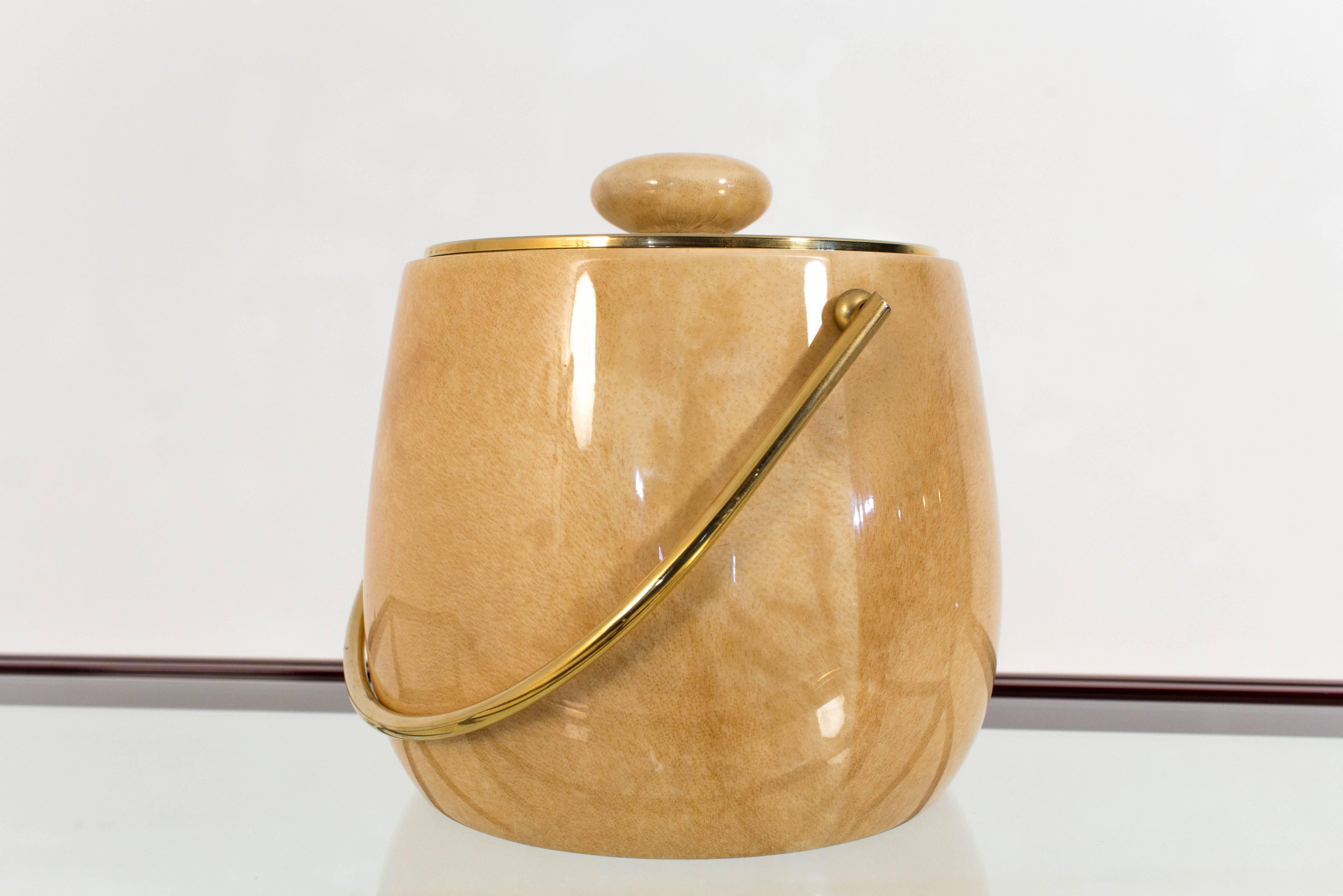 Elegant Mid-Century Modern ice bucket in goatskin by Aldo Tura.
Original lacquered goatskin with brass-plated handle.
Marked with original label.
