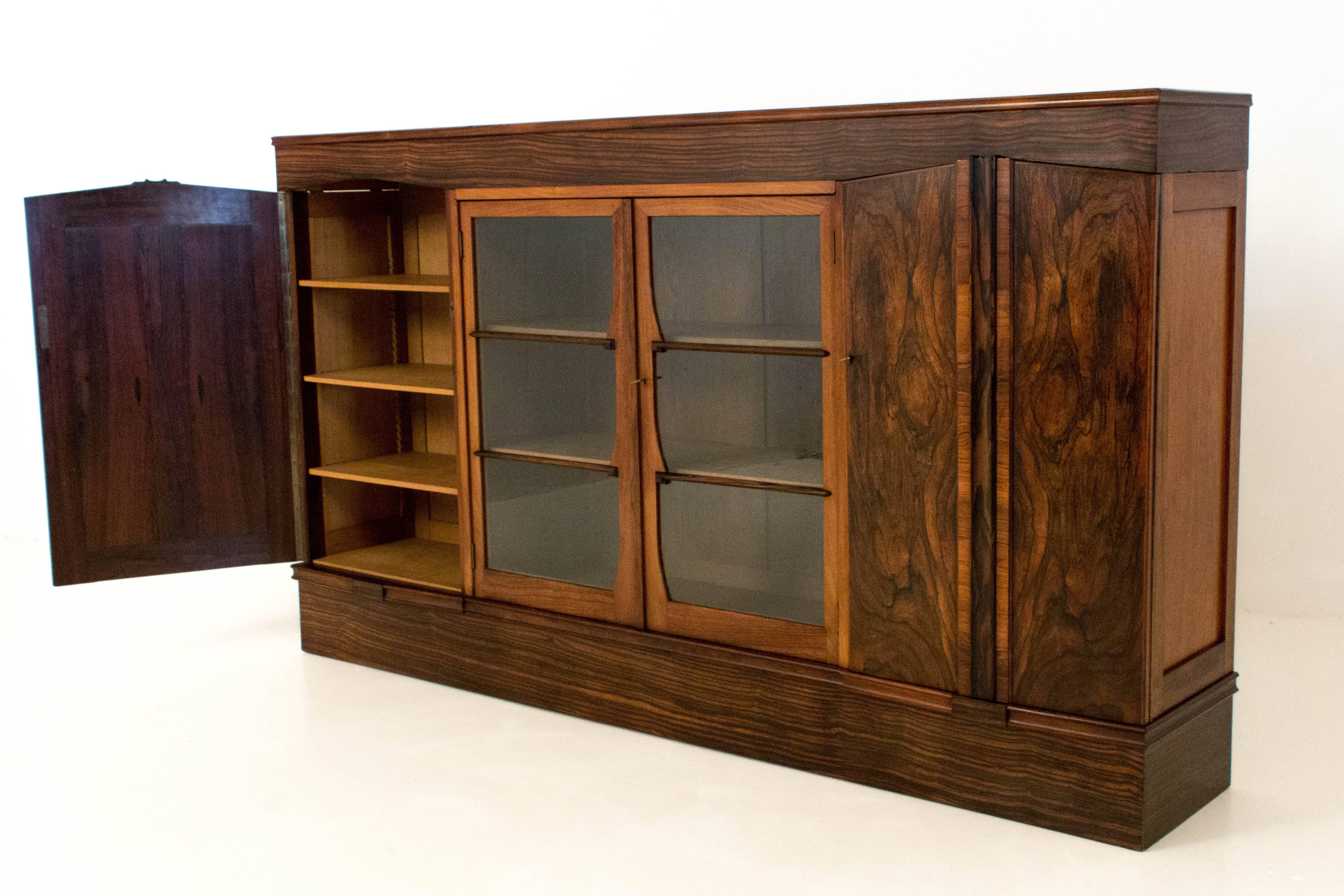 Rare and large Art Deco Amsterdam School bookcase by Max Coini Amsterdam.
Rosewood with Macassar ebony.
Eight original solid oak adjustable shelves.
In good original condition with minor wear consistent with age and use,
preserving a beautiful