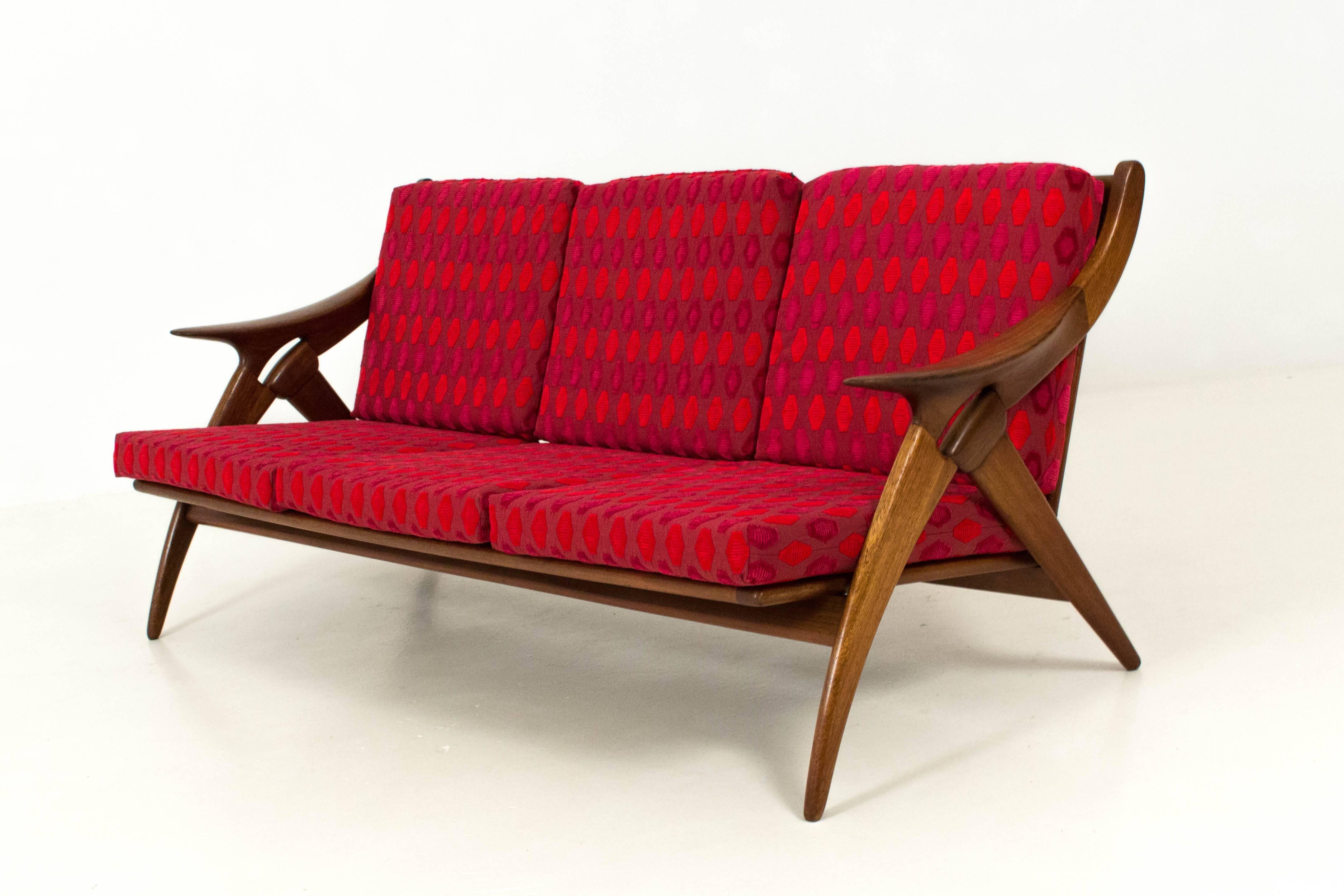 Stunning Mid-Century Modern sofa and lounge chairs by De Ster Gelderland.
Outstanding sculptural design in solid teak.
New upholstered cushions with a funky fabric.
Measurements sofa: H:76 cm x W: 168 cm x D:60 cm.
Measurements lounge chairs: H:
