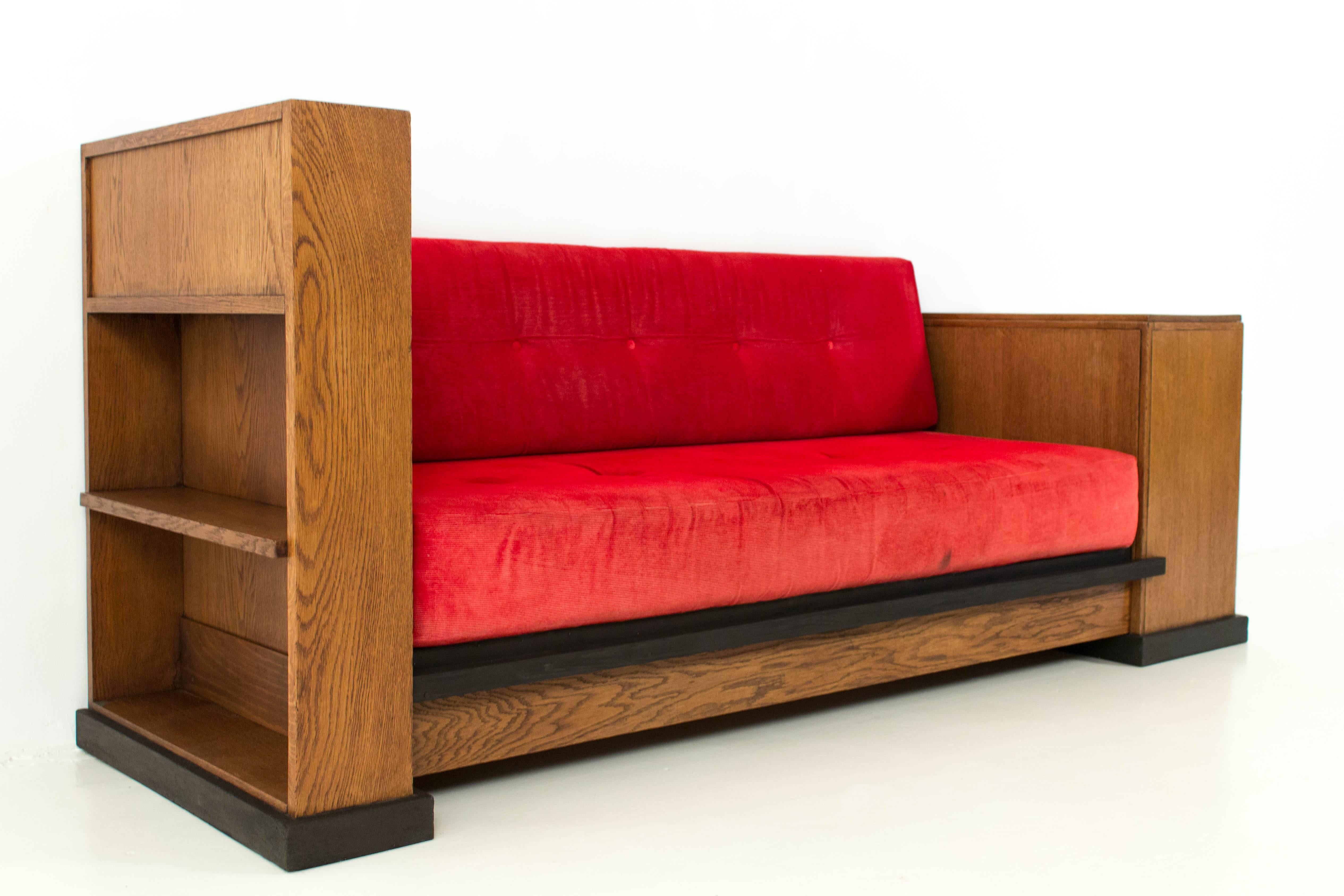Rare Art Deco Haagse School cosy corner or sofa by Jan Brunott.
Solid oak with original ebonized lining.
The red corduroy cushions are slightly faded.
This sofa can be taken apart for easy transportation.
In good original condition with minor