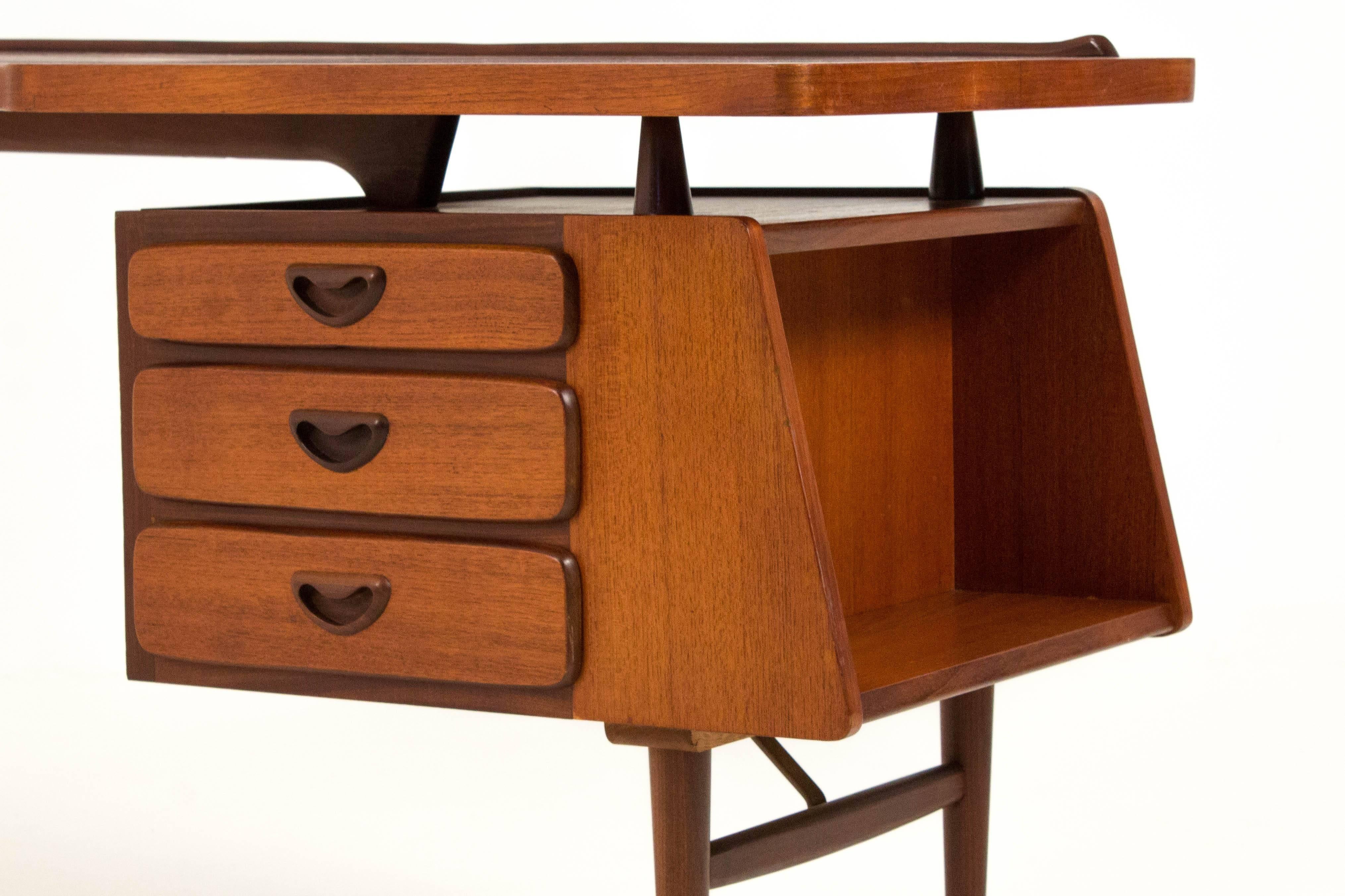 Iconic Mid-Century Modern desk by Louis Van Teeffelen for Webe, 1959.
Teak with brass supports.
Striking design with floating top.
Marked with manufacturers label.
In very good condition with minor wear consistent with age and use,
preserving a
