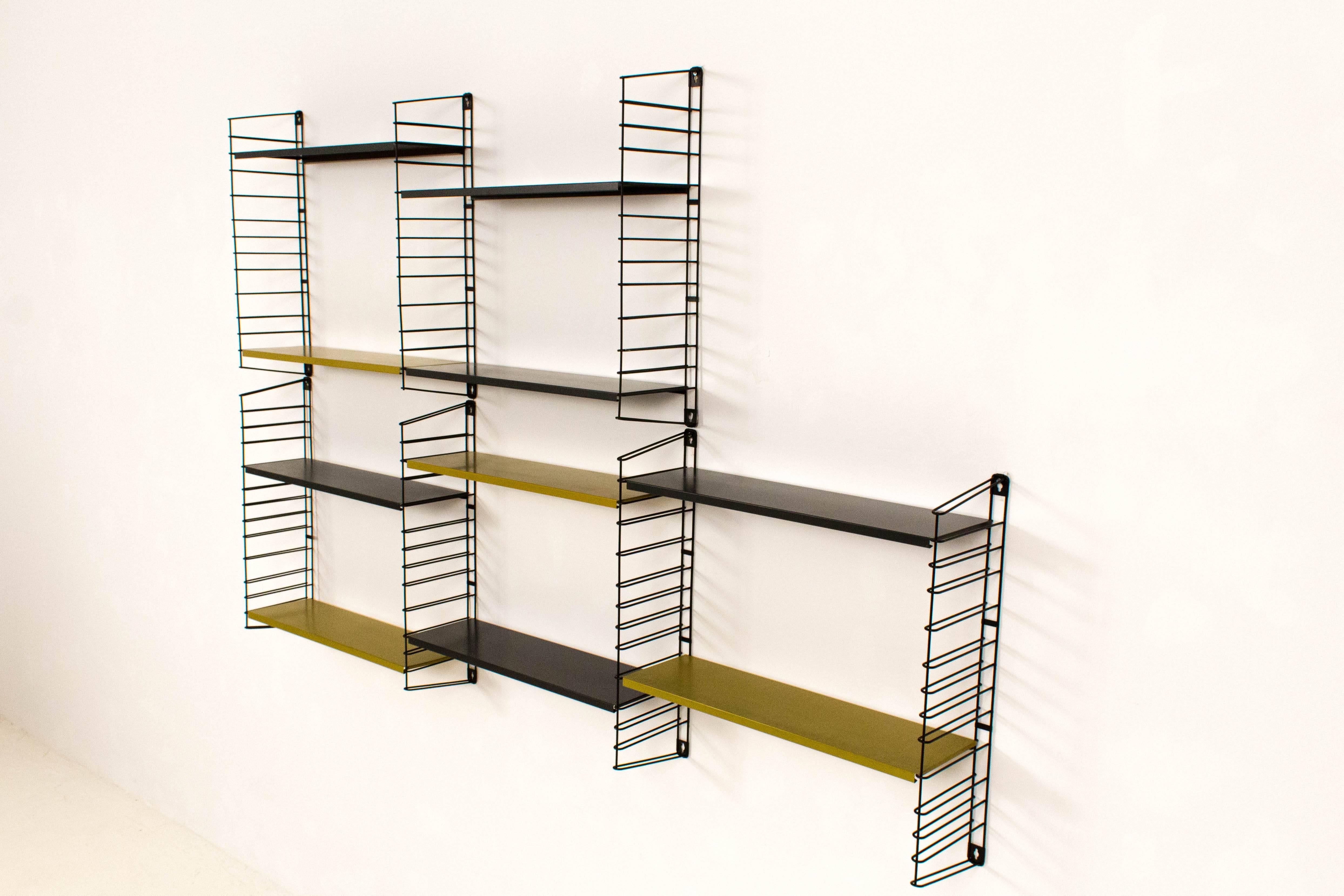 Rare colored metal wall unit by A. Dekker for Tomado, Holland, 1960s.
Five original black shelves and four original moss green shelves.
In good original condition with minor wear consistent with age and use, preserving a beautiful patina.