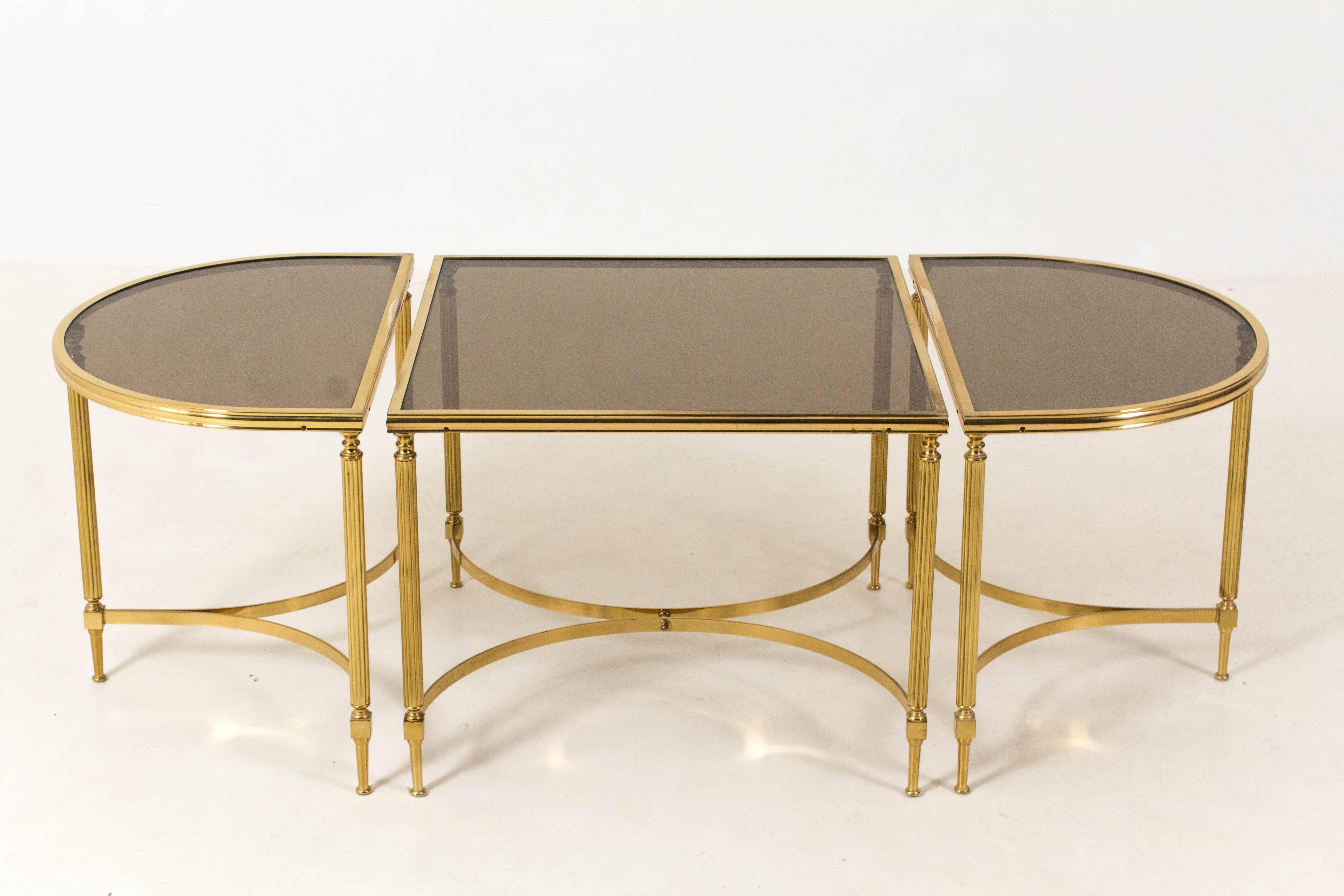 Stunning Hollywood Regency Maison Jansen three-piece cocktail table.
Solid brass frames with smoked glass tops.
In good original condition.
Measurements: Large table: 66 cm x 66 cm.
Measurements: oval table: 66 cm x 42.5 cm.