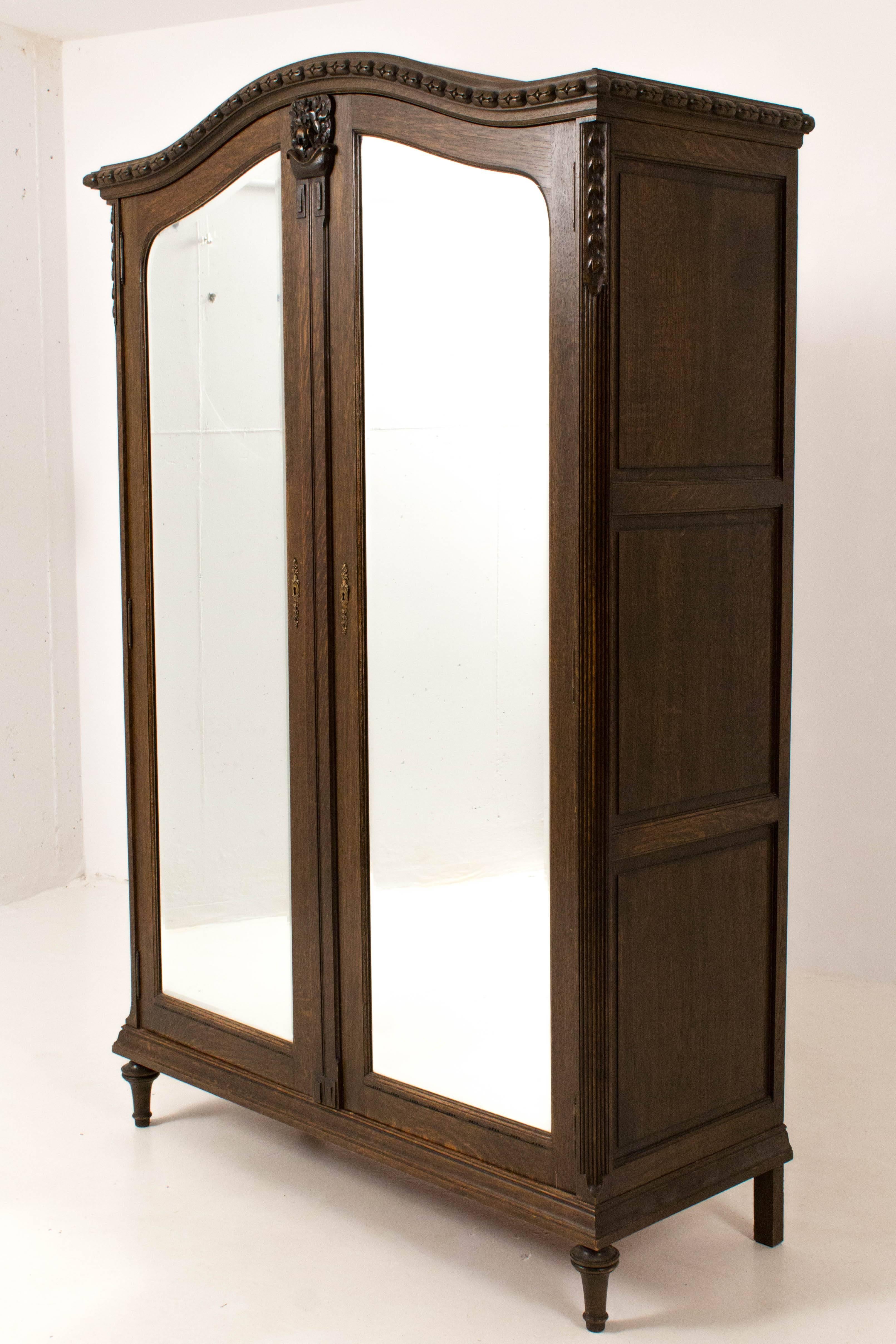 Stunning French Art Nouveau wardrobe with original glass doors 1900s.
Solid oak with nice carved details.
Lock and key are in good working order.
Wardrobe can be taken apart in ten pieces.
In good original condition with minor wear consistent