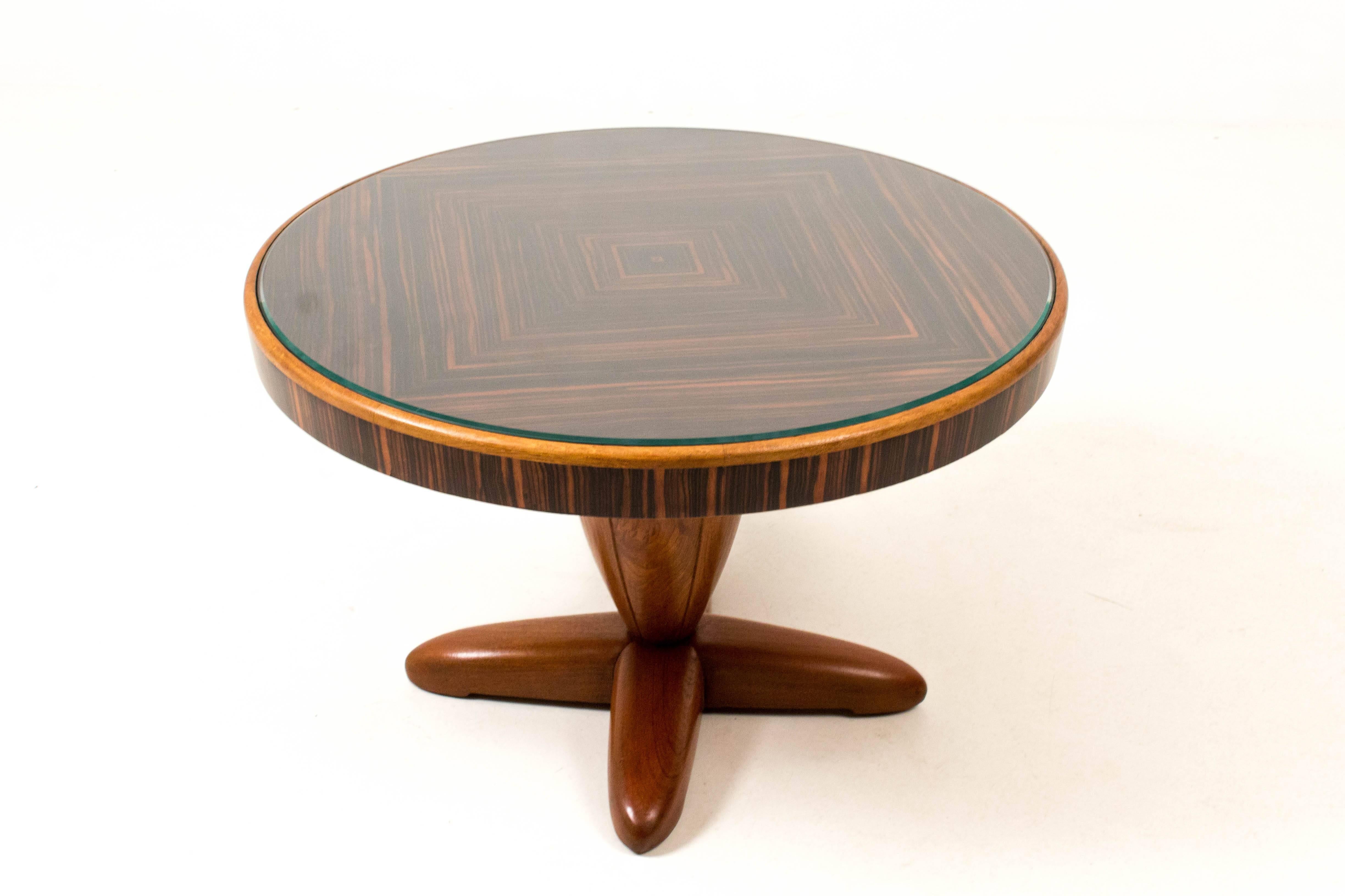 Stunning and rare Art Deco coffee table by Paul Bromberg for Pander 1931.
Solid teak base and Macassar ebony veneered top.
Beveled glass cover.
Executed with ball-bearing, enabling the top to rotate.
In good original condition with minor wear