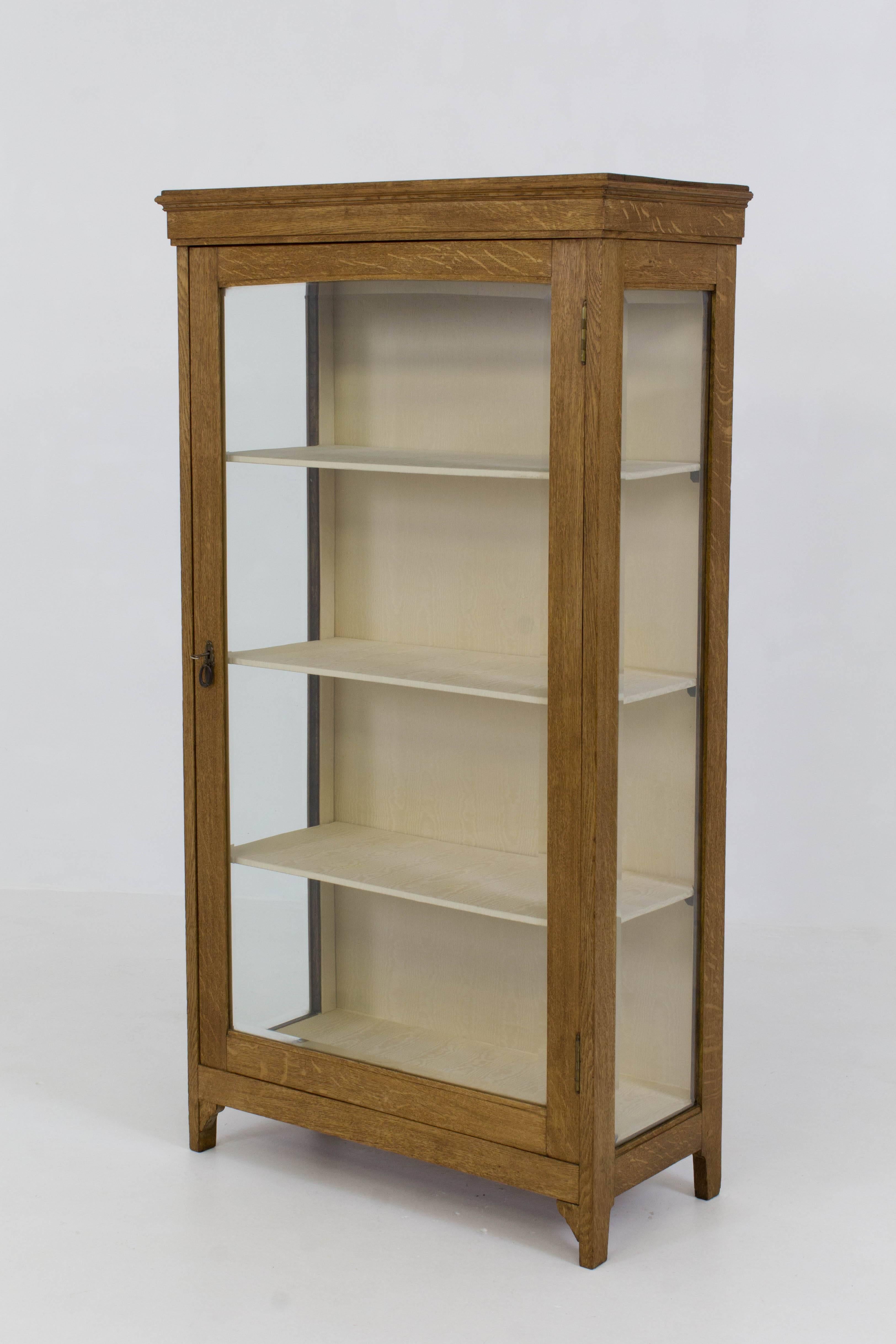 Stylish Dutch Art Nouveau vitrine with beveled glass 1900s.
Solid oak with three shelves wrapped in fabric.
In good original condition with minor wear consistent with age and use,
preserving a beautiful patina.
