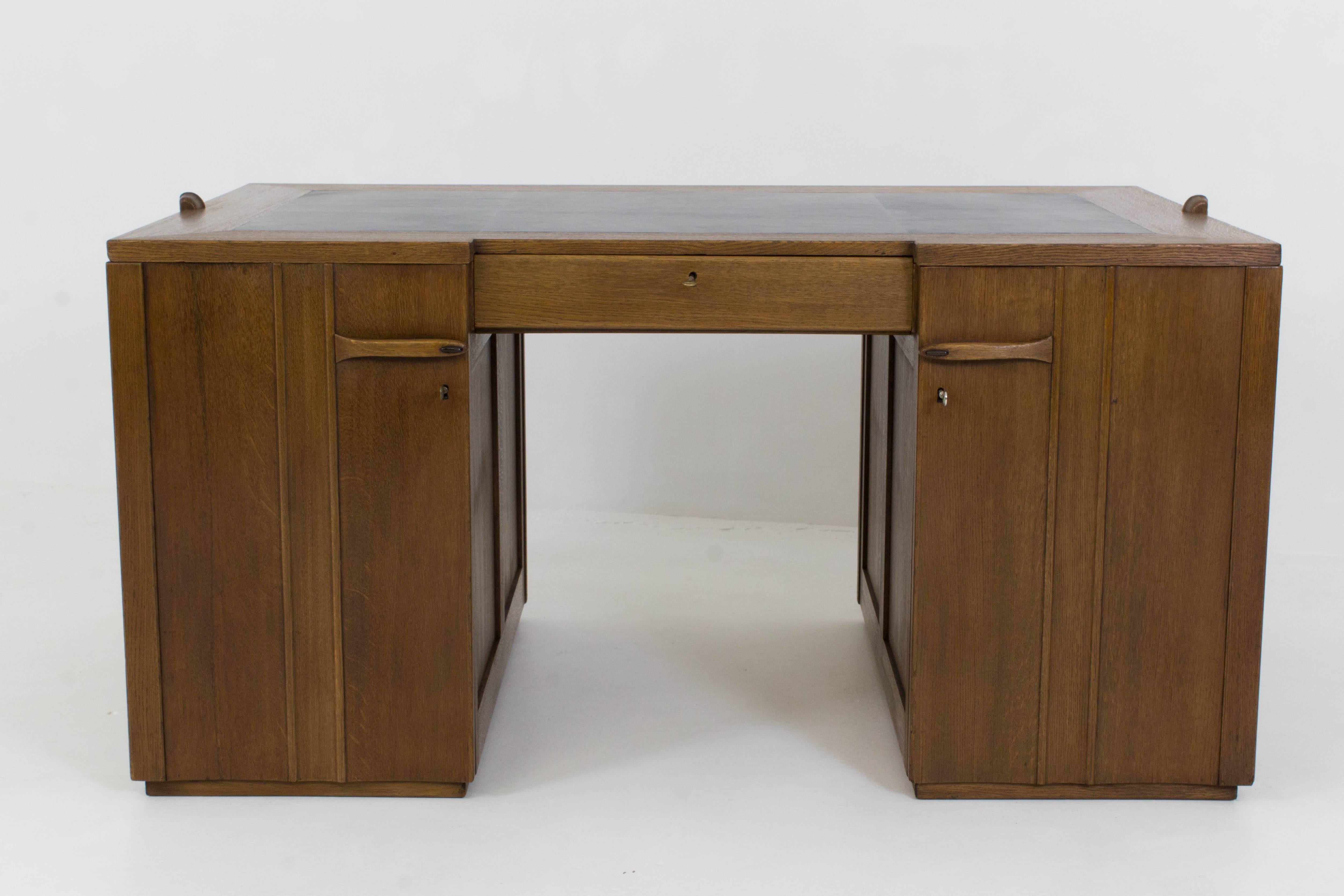 Important and rare Art Deco Amsterdam School desk by Paul Bromberg for Pander 1924.
Striking design with dark blue leather top.
Marked with metal tag Pander and three original keys marked Pander.
In good original condition with minor wear