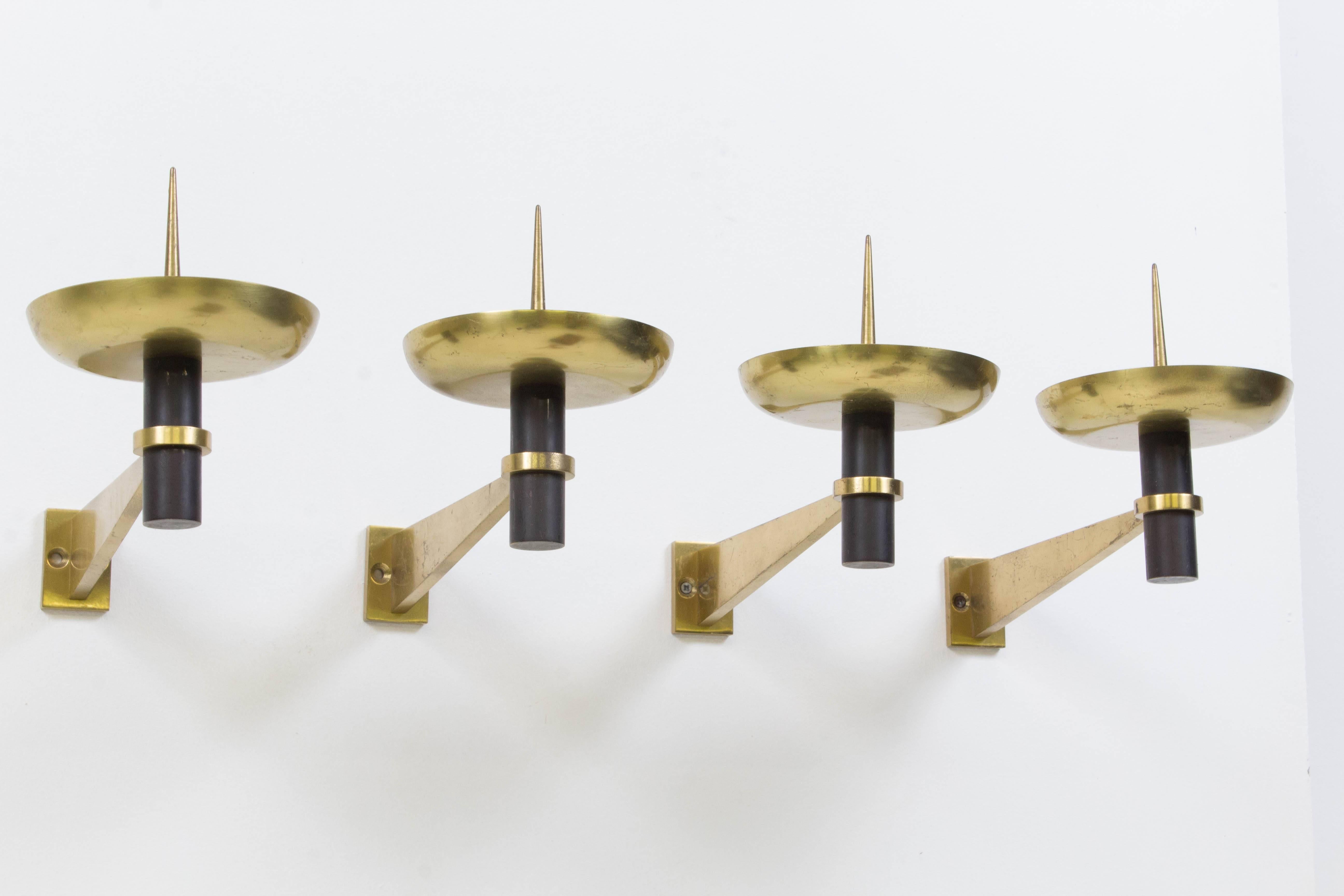 Rare set of four French Mid-Century Modern wall candle sconces, 1950s.
Solid brass with black lacquered metal.
Striking modernist design.
Some wear on the brass that goes on the wall.
In good original condition with minor wear consistent with