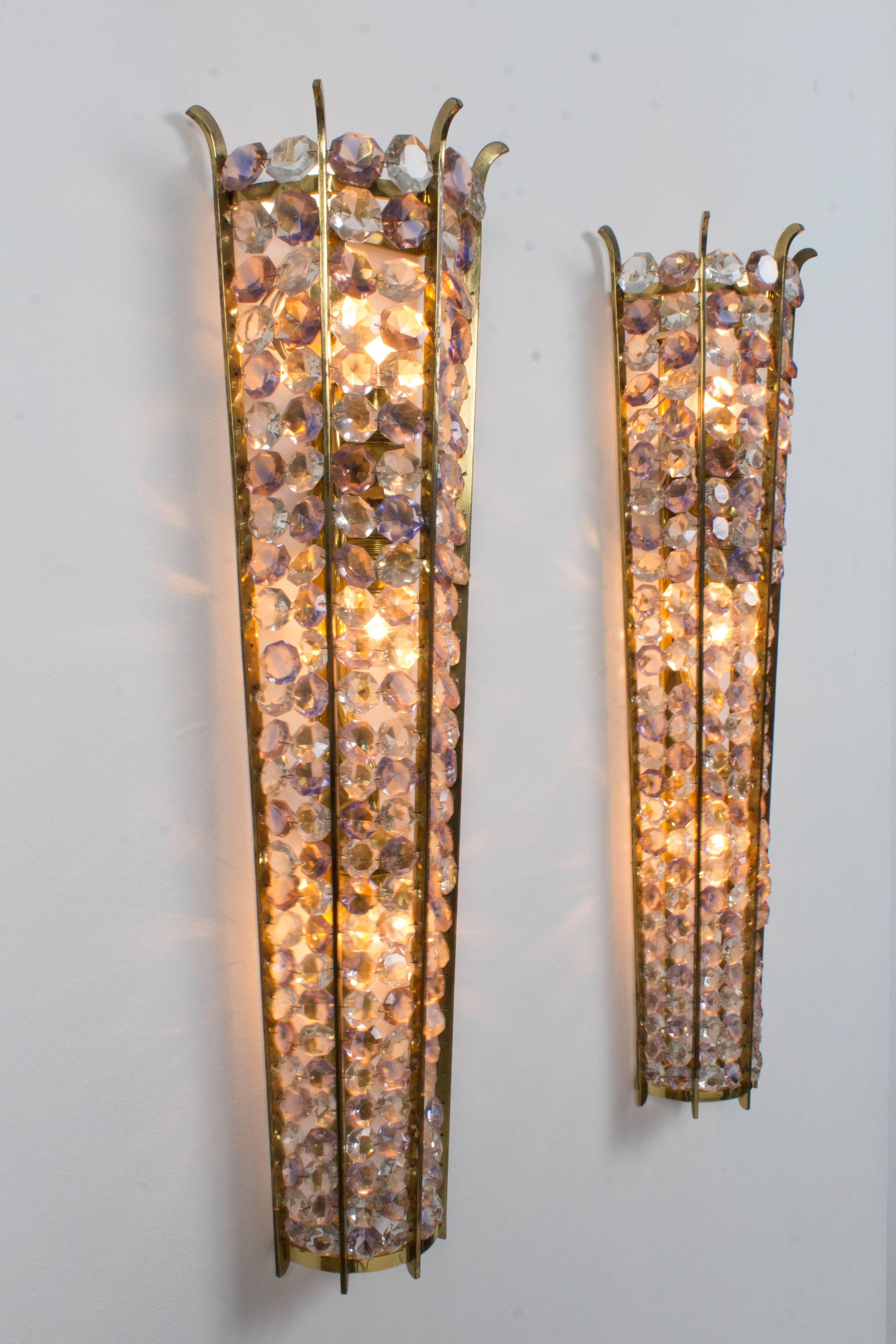 Magnificent pair of large Italian Mid-Century Modern sconces, 1970s.
Original solid brass frames with crystal glass.
Three original sockets.
In very good condition and the color of the glass is fabulous.