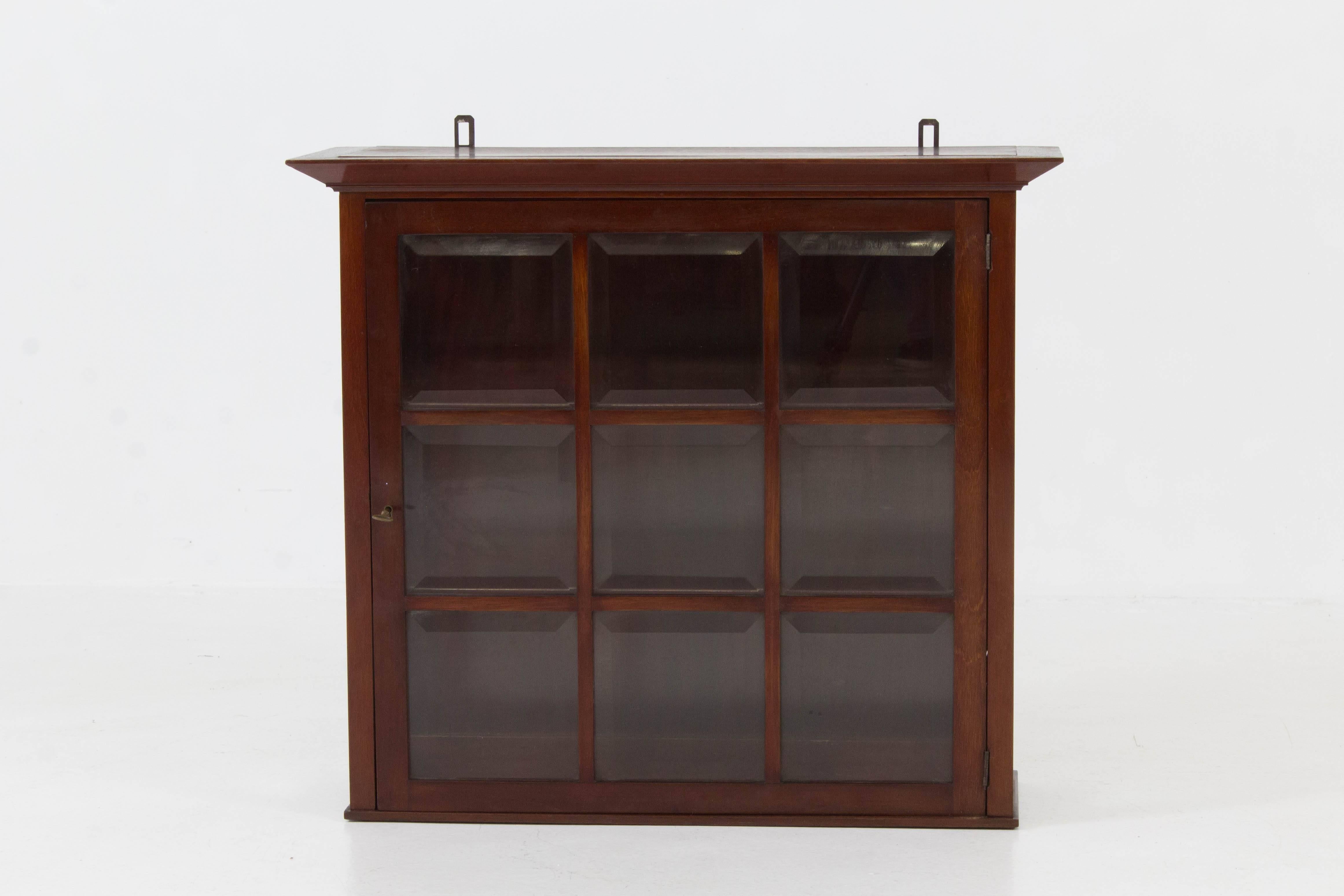 Elegant Dutch Art Nouveau wall cabinet with beveled glass, 1900s.
Solid mahogany with original key.
In good original condition with minor wear consistent with age and use,
preserving a beautiful patina.