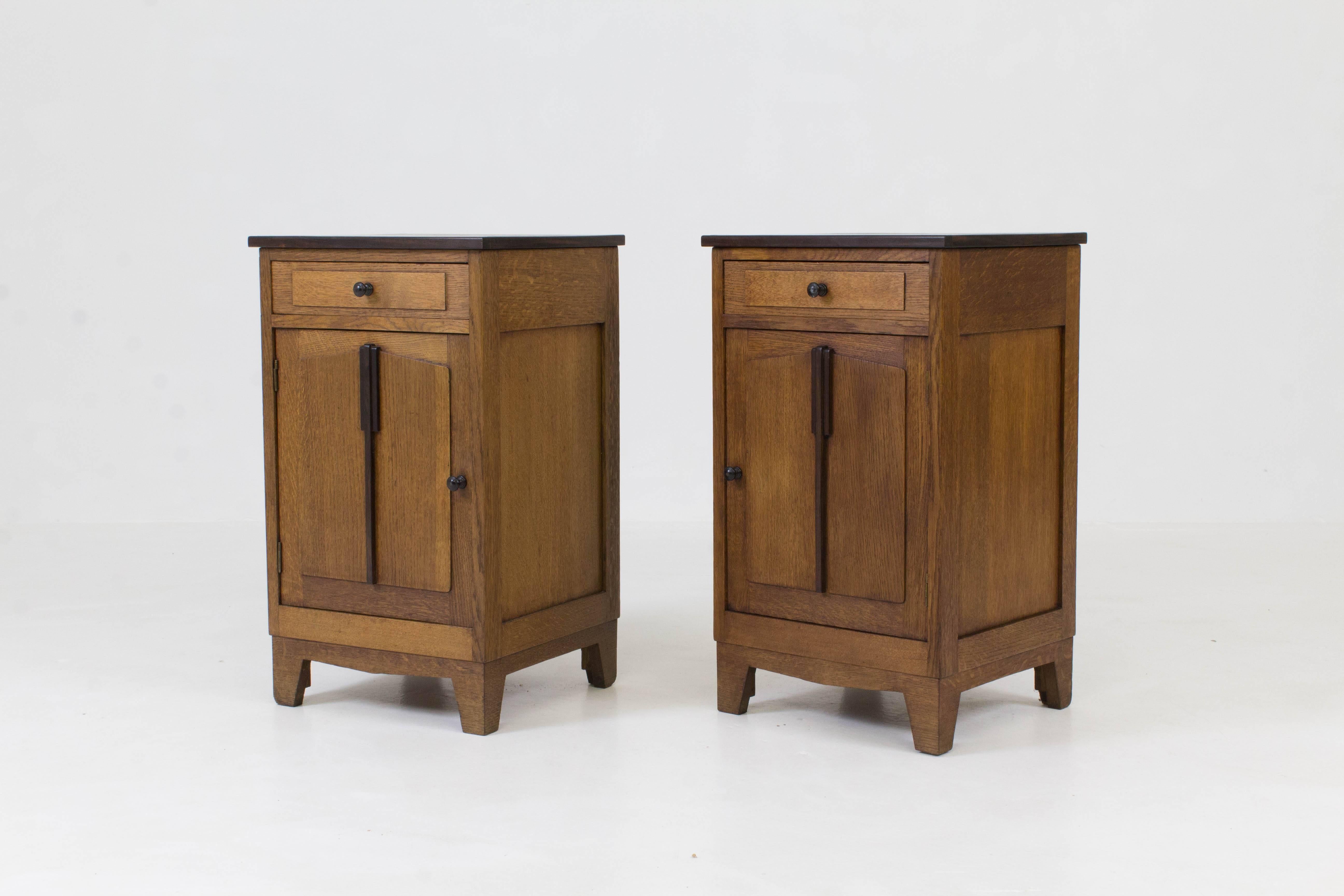 Striking pair of Dutch Art Deco Amsterdam School nightstands, 1920s.
Solid oak with Macassar ebony veneered tops.
Solid Macassar ebony knobs and lining on the drawers and doors.
In very good condition with minor wear consistent with age and