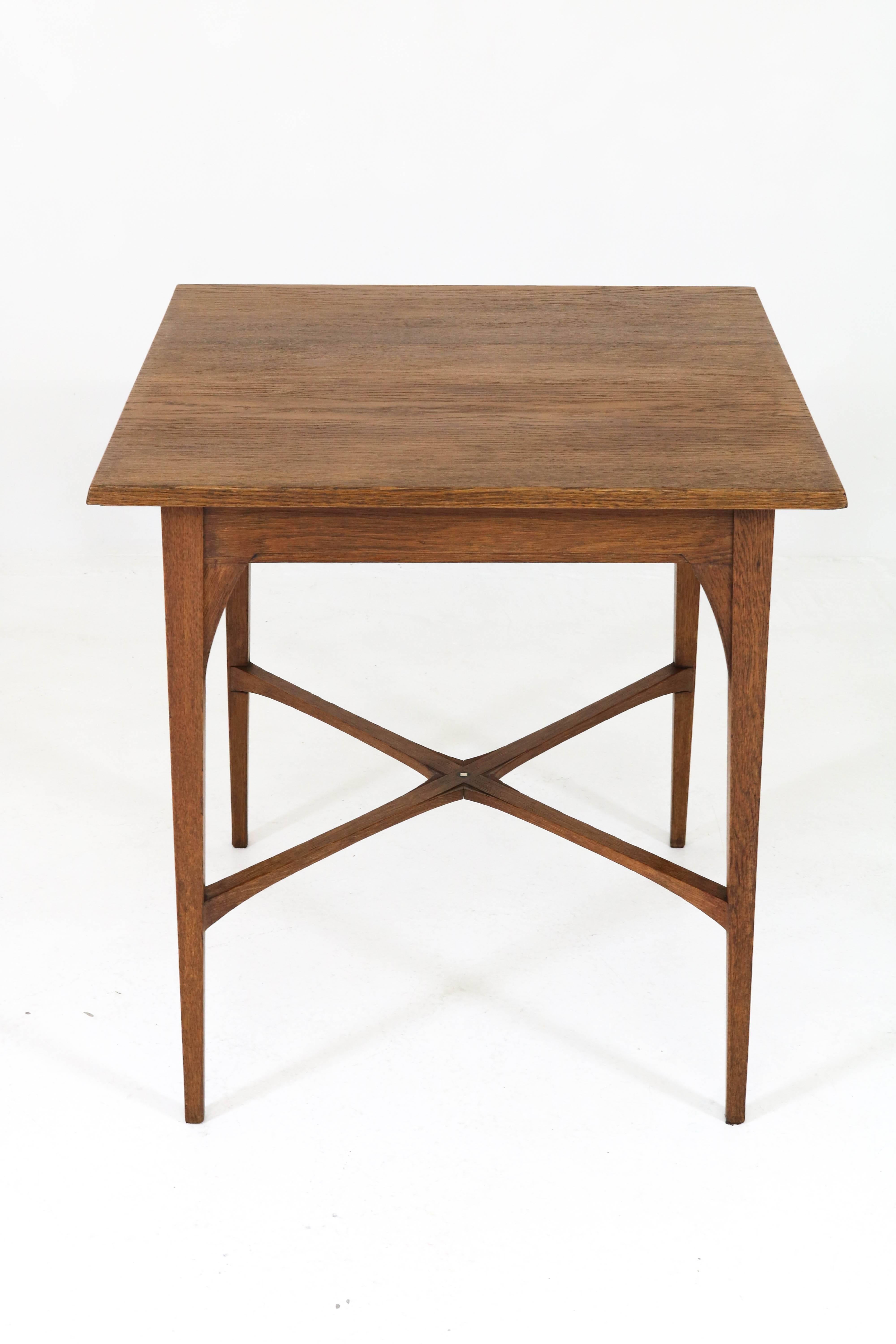 Elegant Dutch Arts & Crafts occasional table by J.A. Huizinga, 1900s.
Solid oak with inlay on the cross between the legs.
Marked with metal tag.
In good original condition with minor wear consistent with age and use,
preserving a beautiful