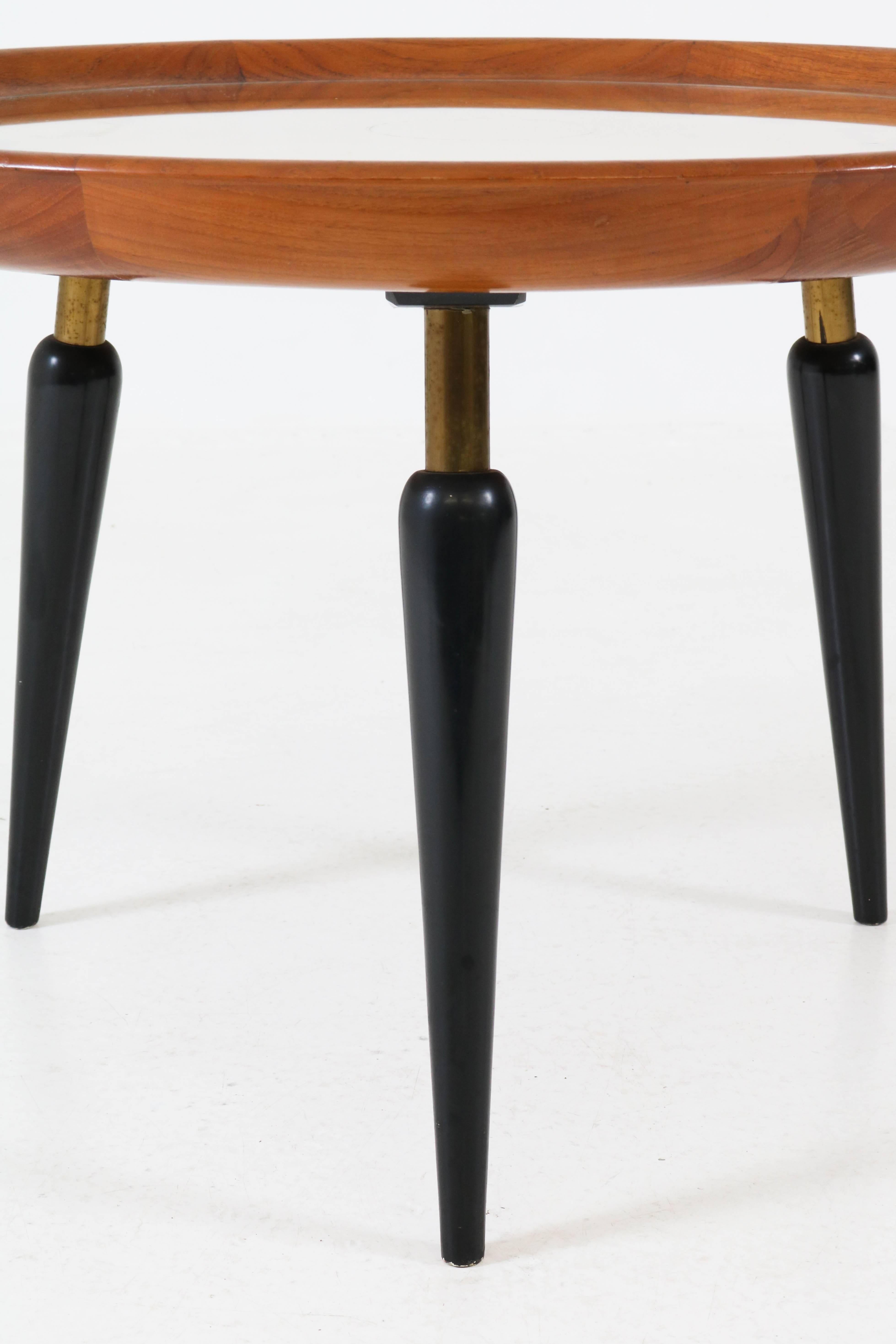 Elegant Italian Mid-Century Modern fruitwood coffee table with inlay, 1950s.
Original black lacquered legs.
Round glass top.
In very good condition with minor wear consistent with age and use,
preserving a beautiful patina.