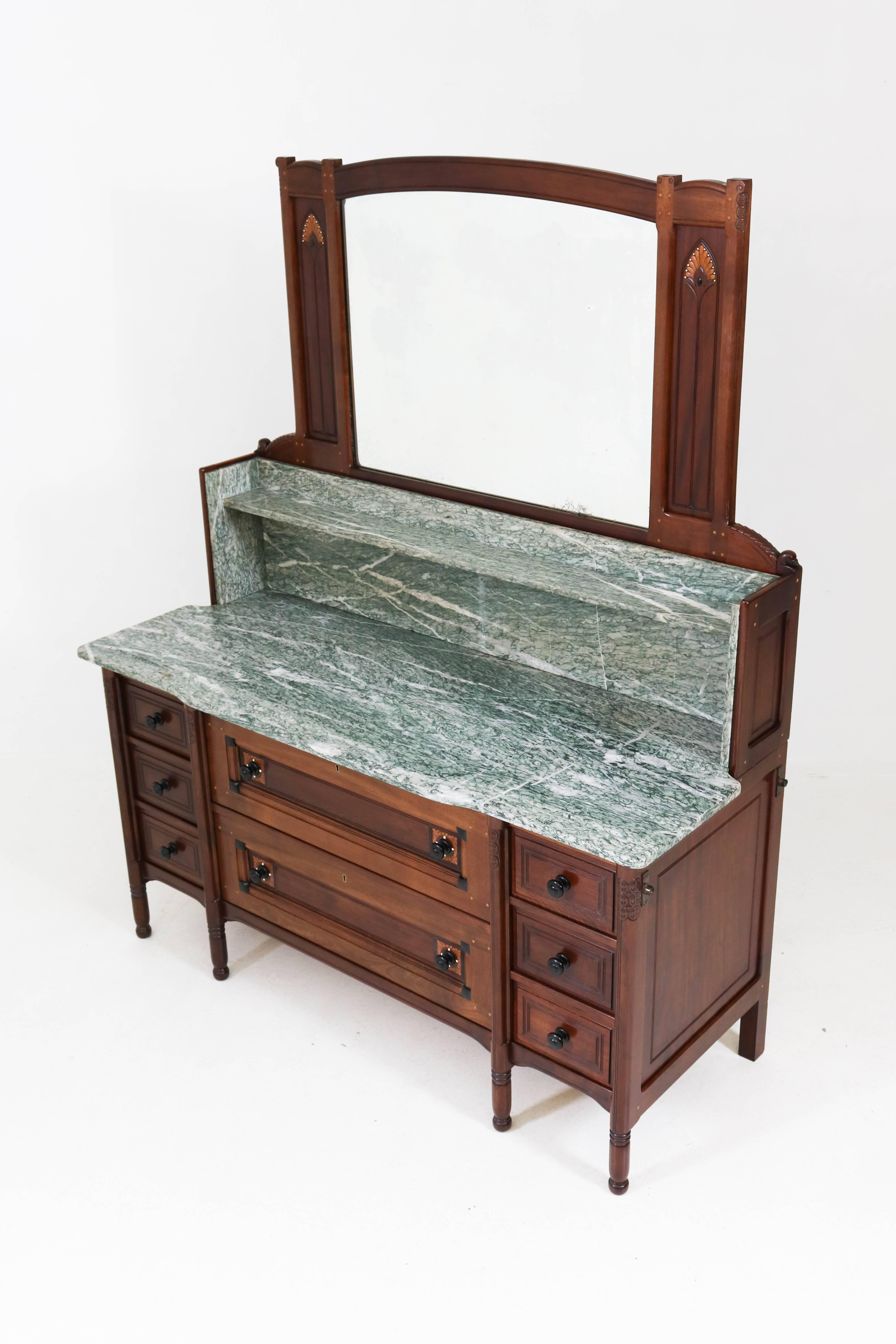 Very rare Arts & Crafts Art Nouveau vanity or dresser by Jac. van den Bosch for 't Binnenhuis Amsterdam, 1900s.
Solid mahogany with Macassar ebony, palmwood and inlay.
Original green marble top.
This wonderful one of a kind piece of furniture was