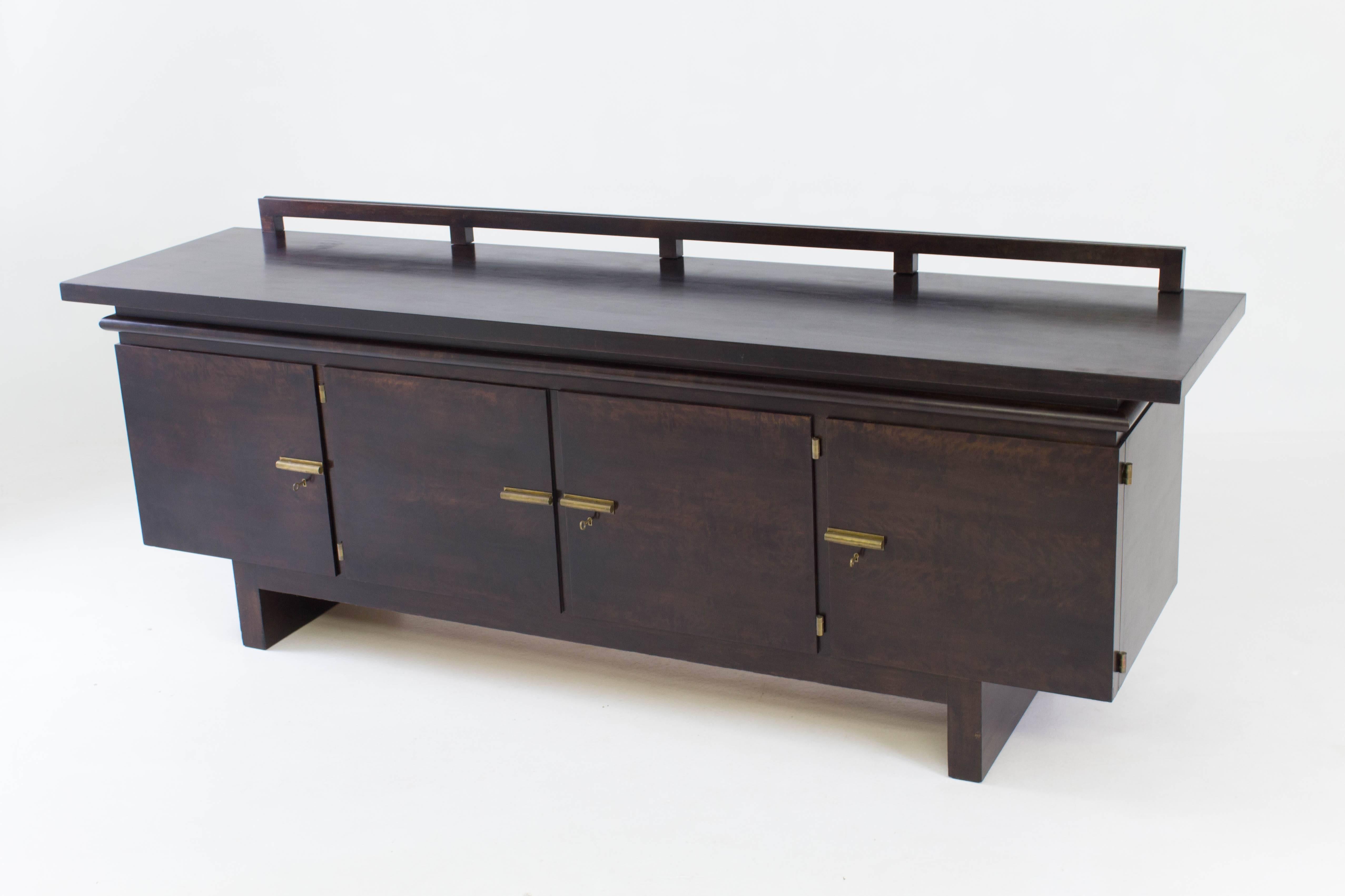 Rare Art Deco Bauhaus sideboard or credenza by Bruno Paul for Berliner Zoo
Werkstätten Berlin 1928.
Dark stained birch veneer with bronze fittings.
Minor veneer bubble on top, see image.
In good original condition with minor wear consistent with
